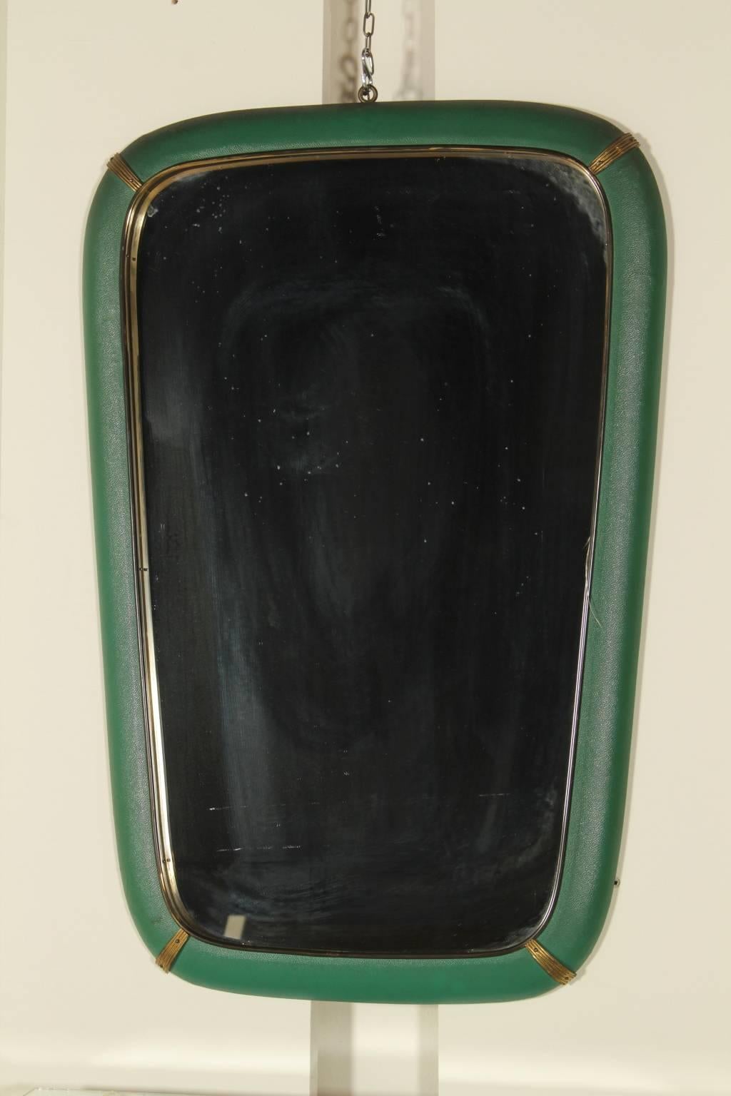 A console with mirror, wood covered with skai leatherette, brass, glass. Manufactured in Italy, 1950s.