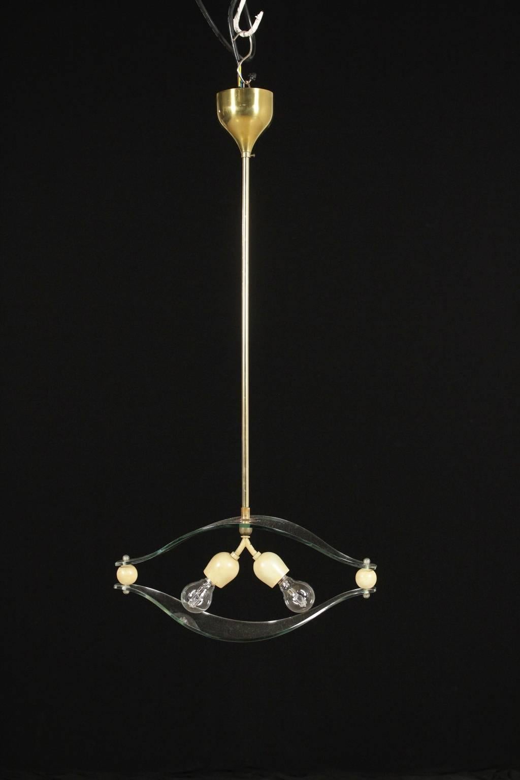 A brass and glass hanging lamp. Manufactured in Italy, 1950s.