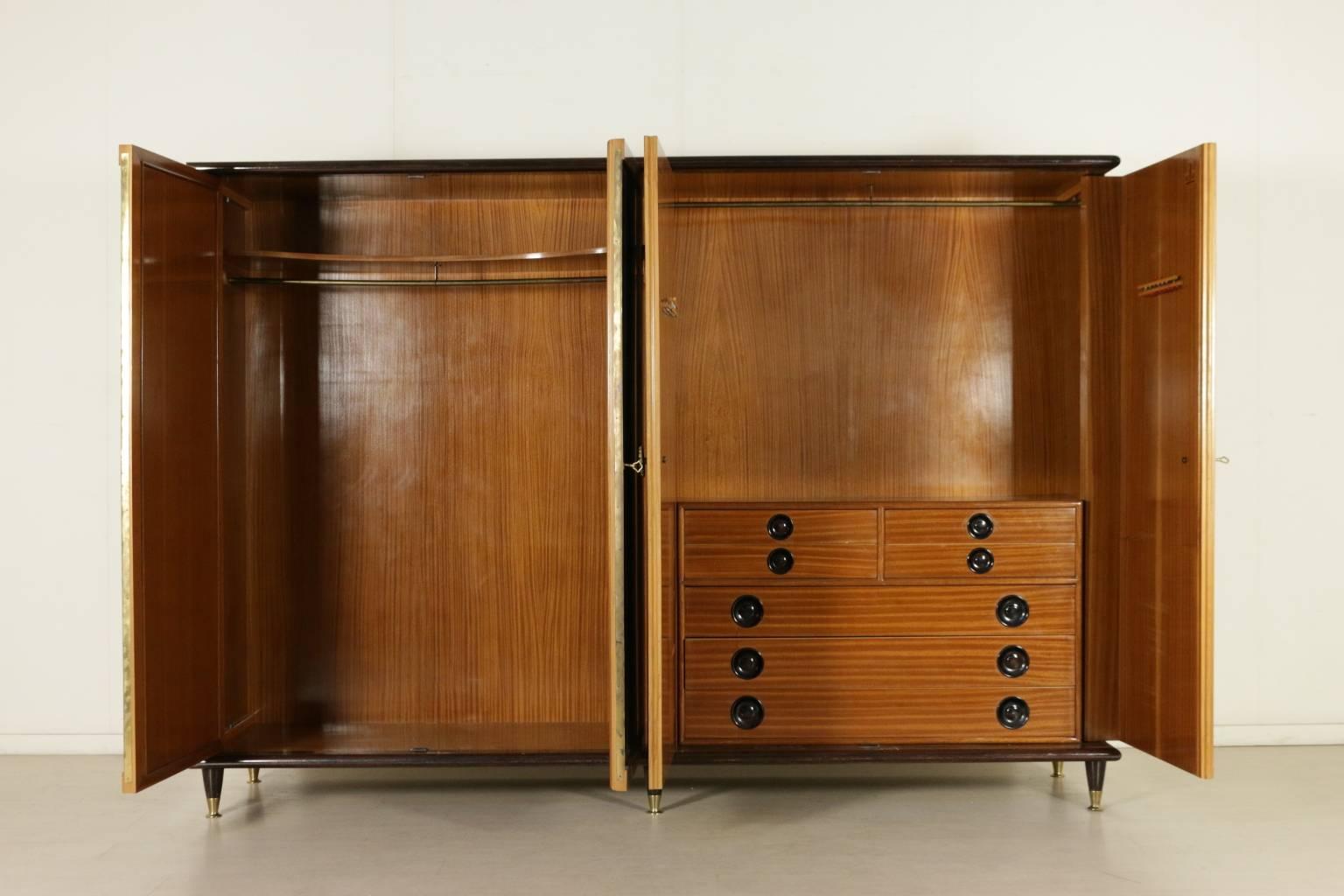 A wardrobe, burl and rosewood veneer, mirror, brass handles and tips. Manufactured in Italy, 1940s-1950s.