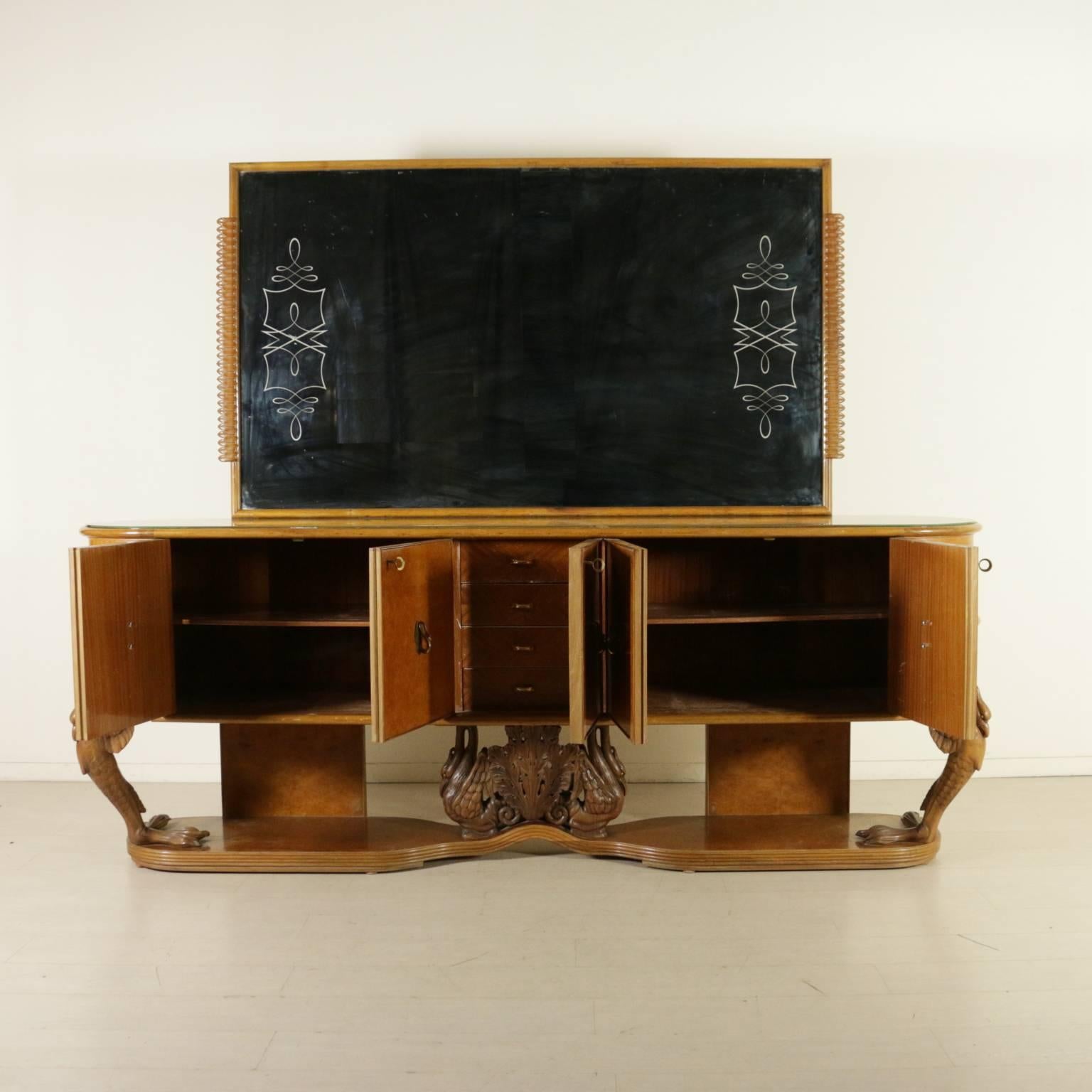 A sideboard with mirror, burl veneer, carved wooden legs, back-treated glass top, brass handles. Manufactured in Italy, 1940s.