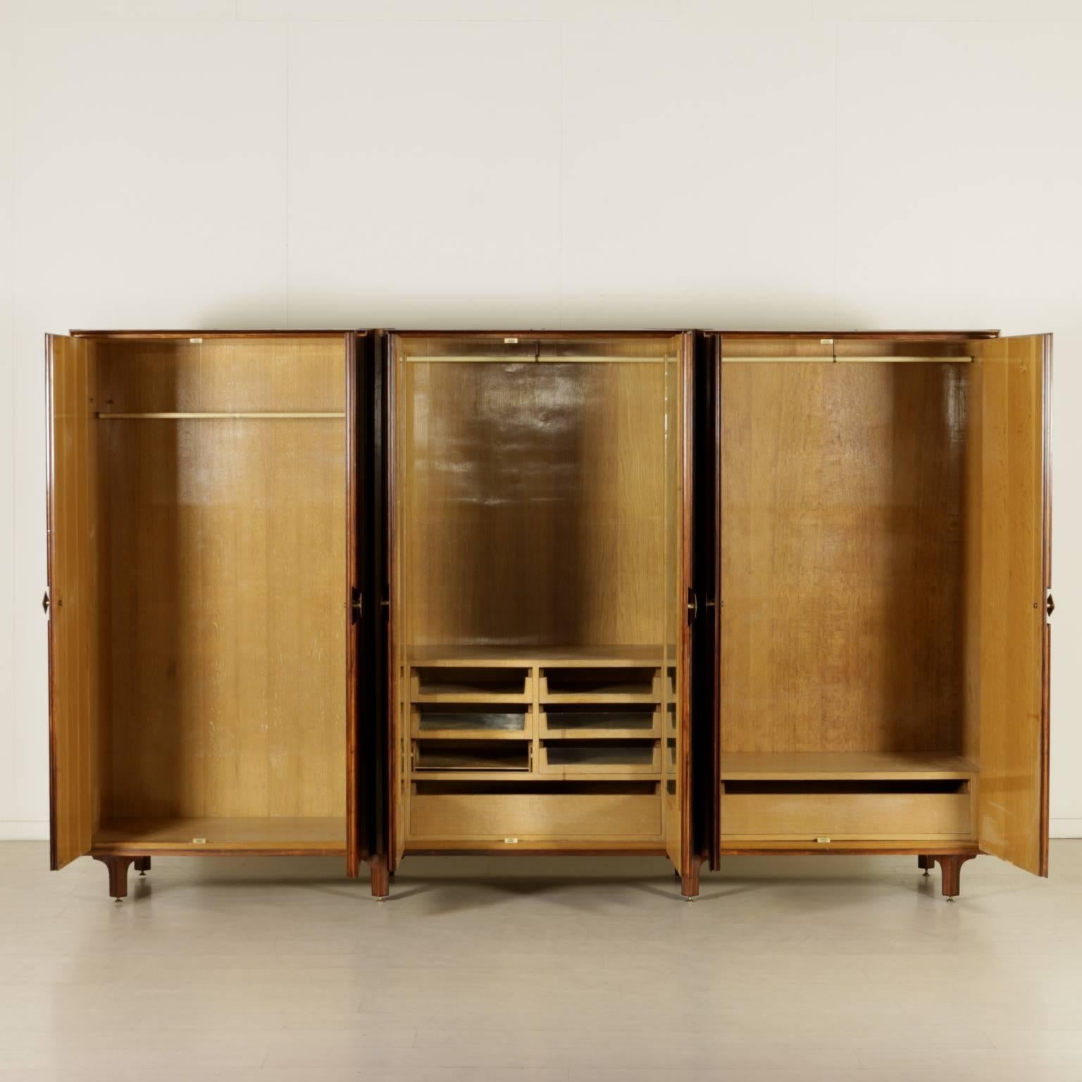 A wardrobe, rosewood veneer, oak veneered interior, brass handles. Manufactured in Italy by Artigiani del Mobile, 1960s.