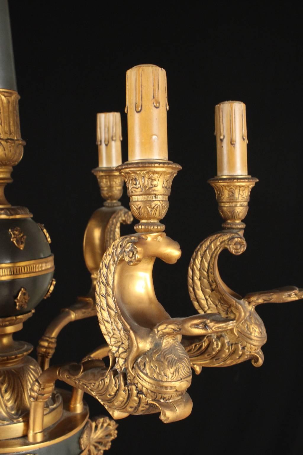 A gilded and burnished bronze chandelier with Empire design, six swan shaped arms. Manufactured in Italy in the late 19th century.