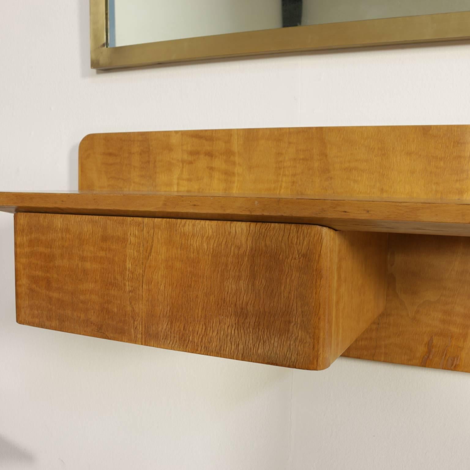 A wall console with mirror, part of a furnishing project designed for a private client's house in Milan. Walnut veneer, brass mirror frame. Manufactured in Italy, 1960s.