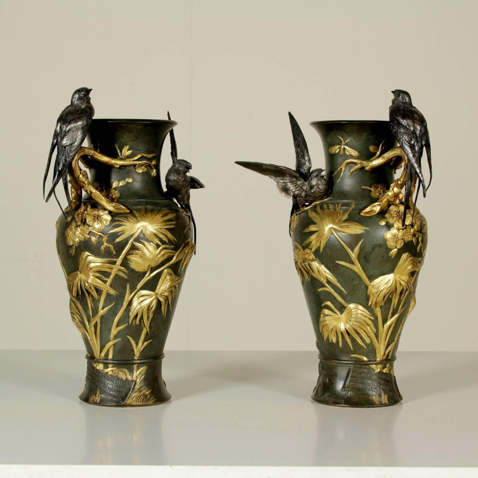 A pair of refined bronze vases with Japoniste taste by Jules Moigniez. Gilt bronze embossed decorations with floral subject and asymmetrical branches with two swallows resting on them. On the base a cartouche with a chanson by Pierre-Jean de