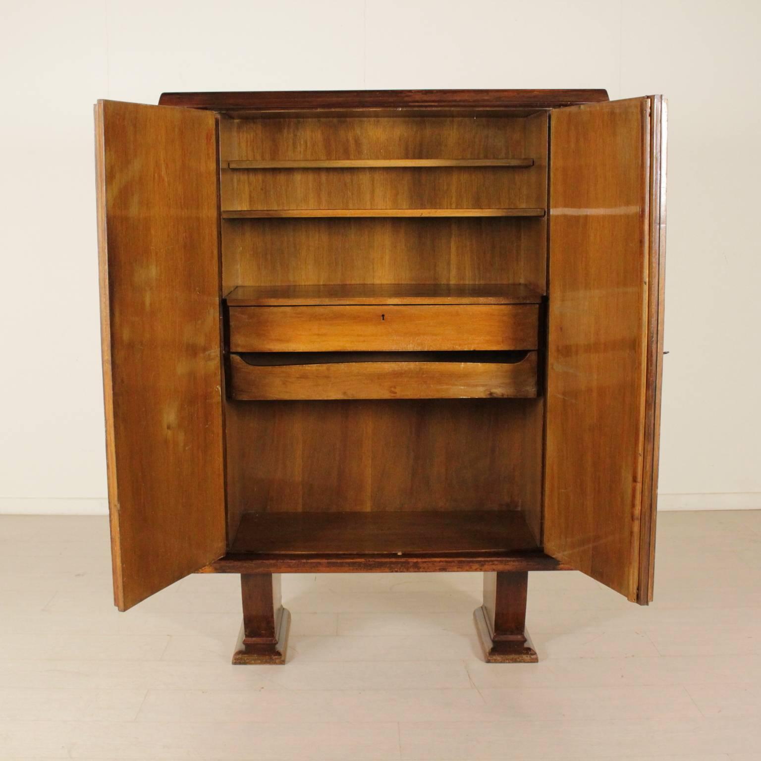 A cabinet, walnut veneer, decorated sides, birch veneered doors with various essences inlaid decorations. Manufactured in Italy, 1940s-1950s.