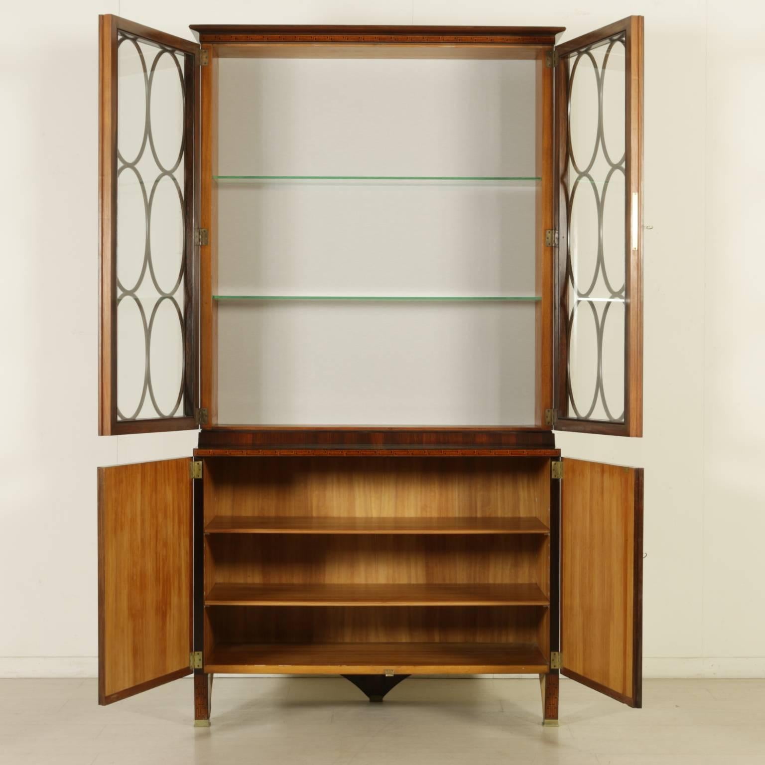 A showcase designed by Paolo Buffa for F.lli Lietti. Two doors, glass raised top. The basement is made of two front supports obtained by shaping the side and a central back support. Cuban mahogany veneer, Greek fret inlays. Manufactured in Italy,