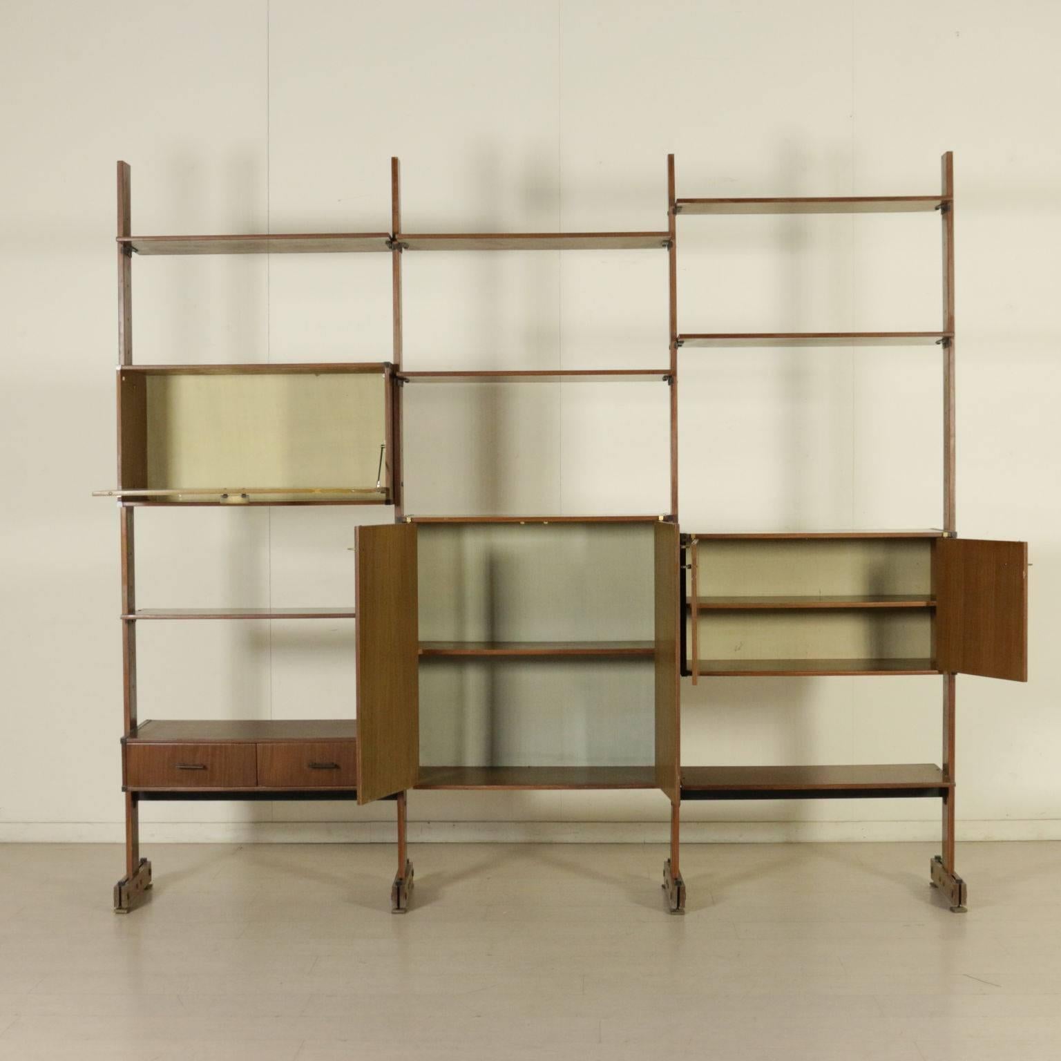 A bookcase with adjustable elements. Mahogany veneer, lacquered and decorated panel, brass. Manufactured in Italy, 1960s.