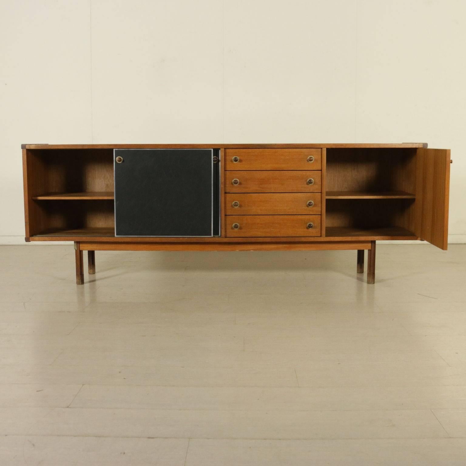 A sideboard with sliding doors and drawers. Teak veneer, leatherette, aluminium, brass. Manufactured in Italy, 1960s.