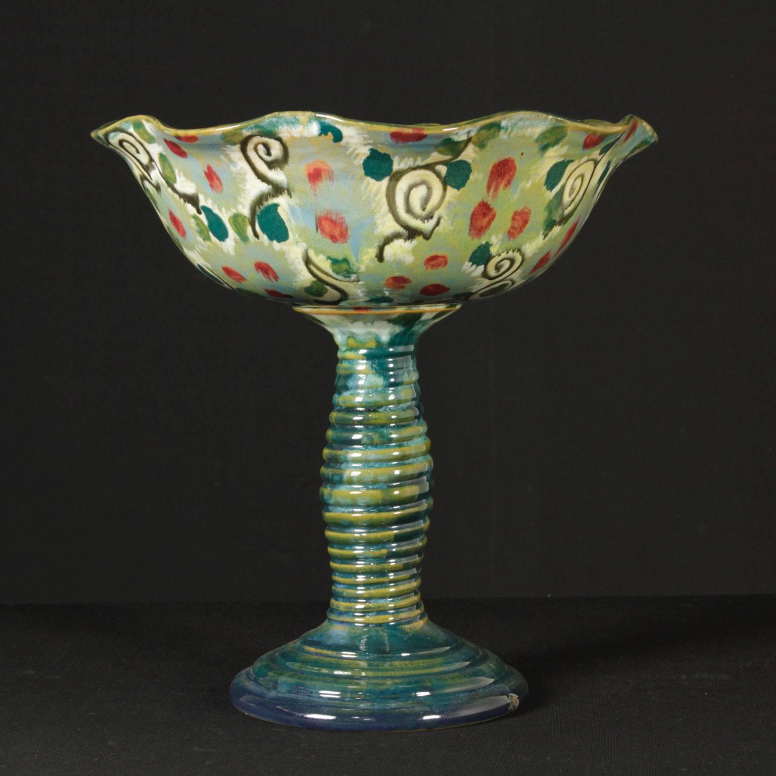 A large centerpiece, polychrome decorated enamelled ceramic. On the bottom, the brand name 