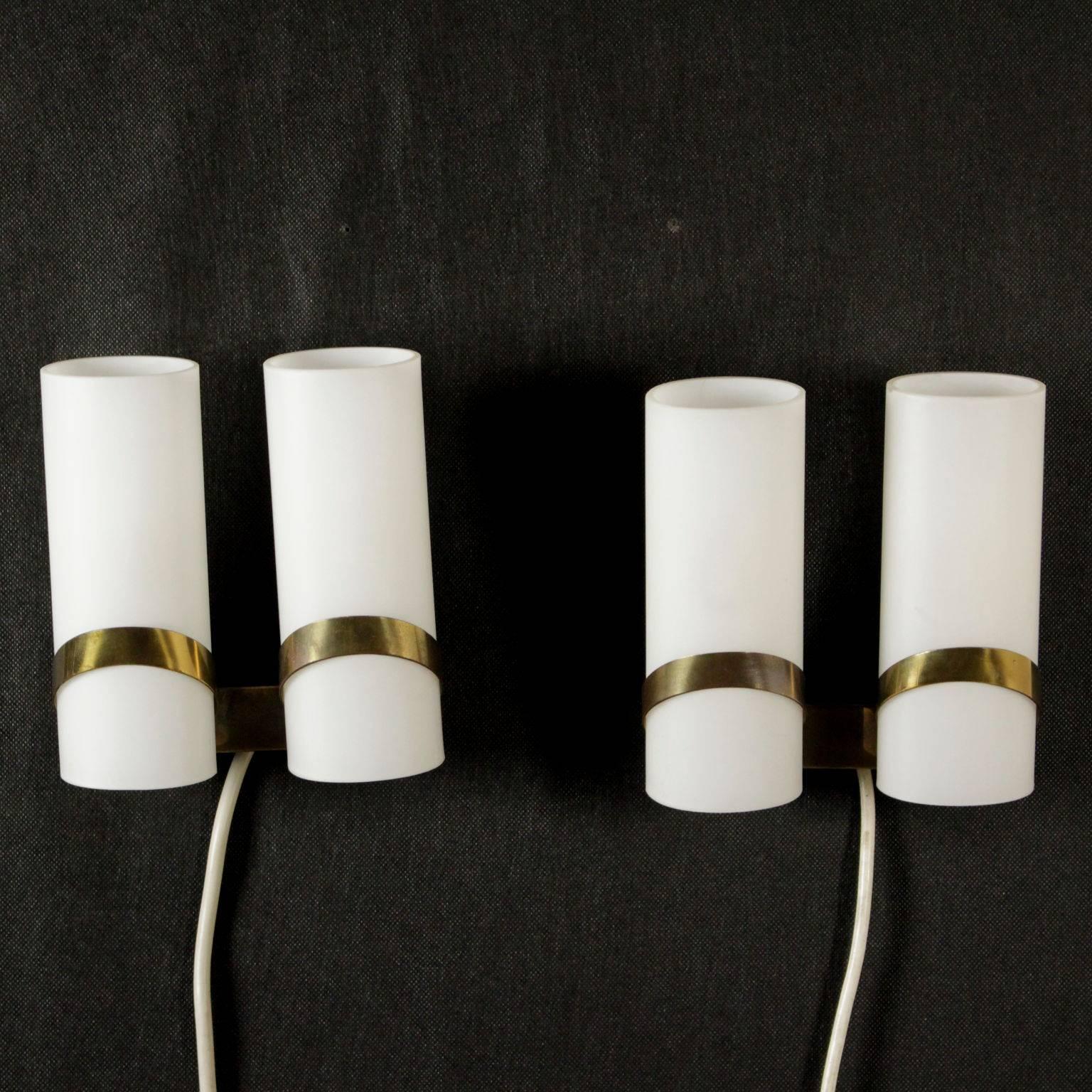 A pair of wall lamps in opal glass and support in brass. Manufactured in Italy, 1960s.