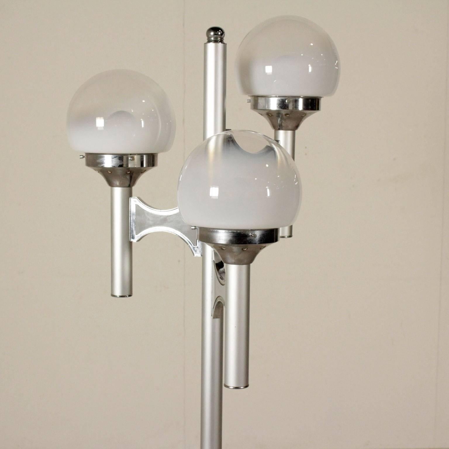 A vintage floor lamp in aluminium, metal and glass. Manufactured in Italy, 1960s-1970s.