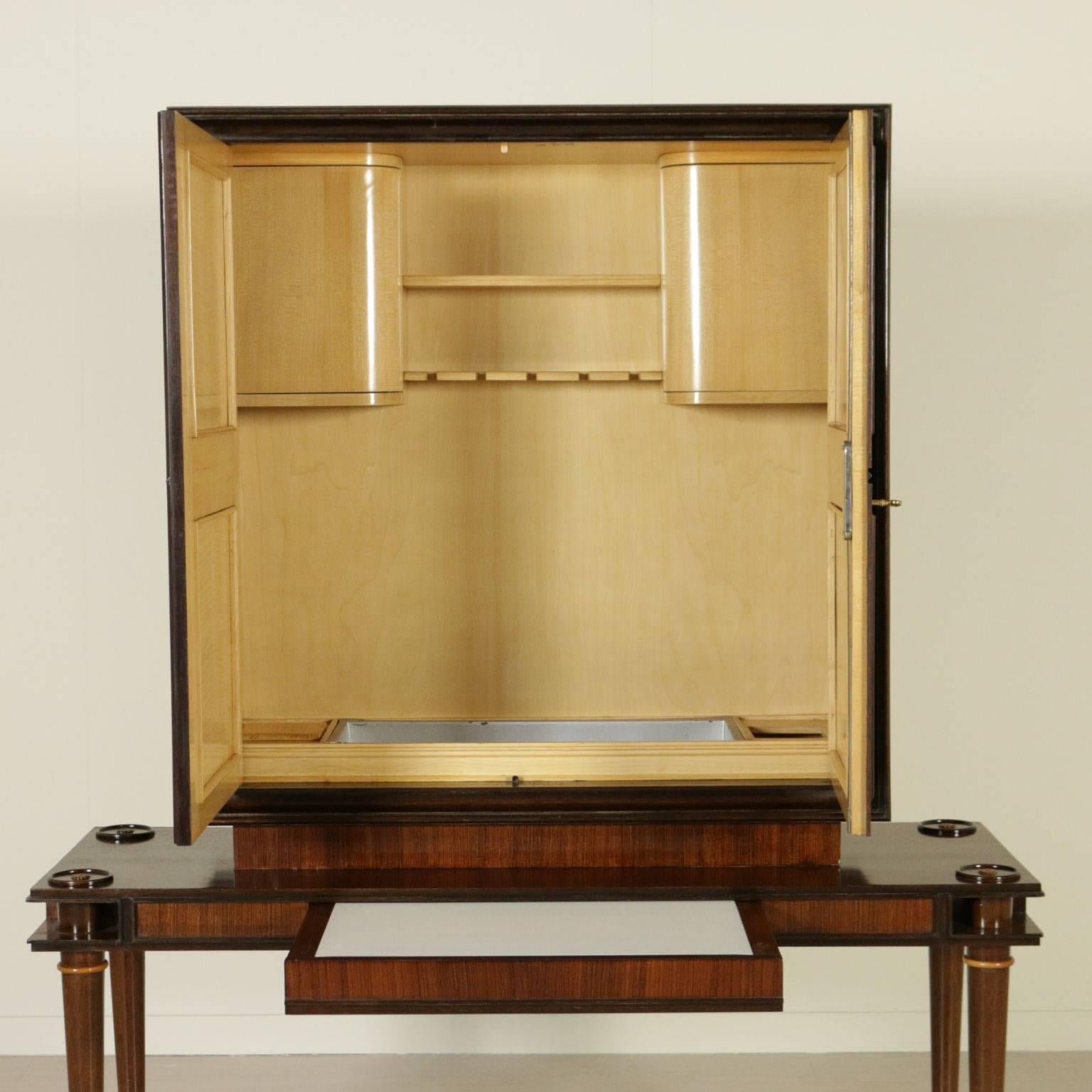 A cabinet with internal bar compartment and extractable opaline glass top. Rosewood veneer with inlaid decorations, poplar veneered interiors. Manufactured in Italy, 1950s.