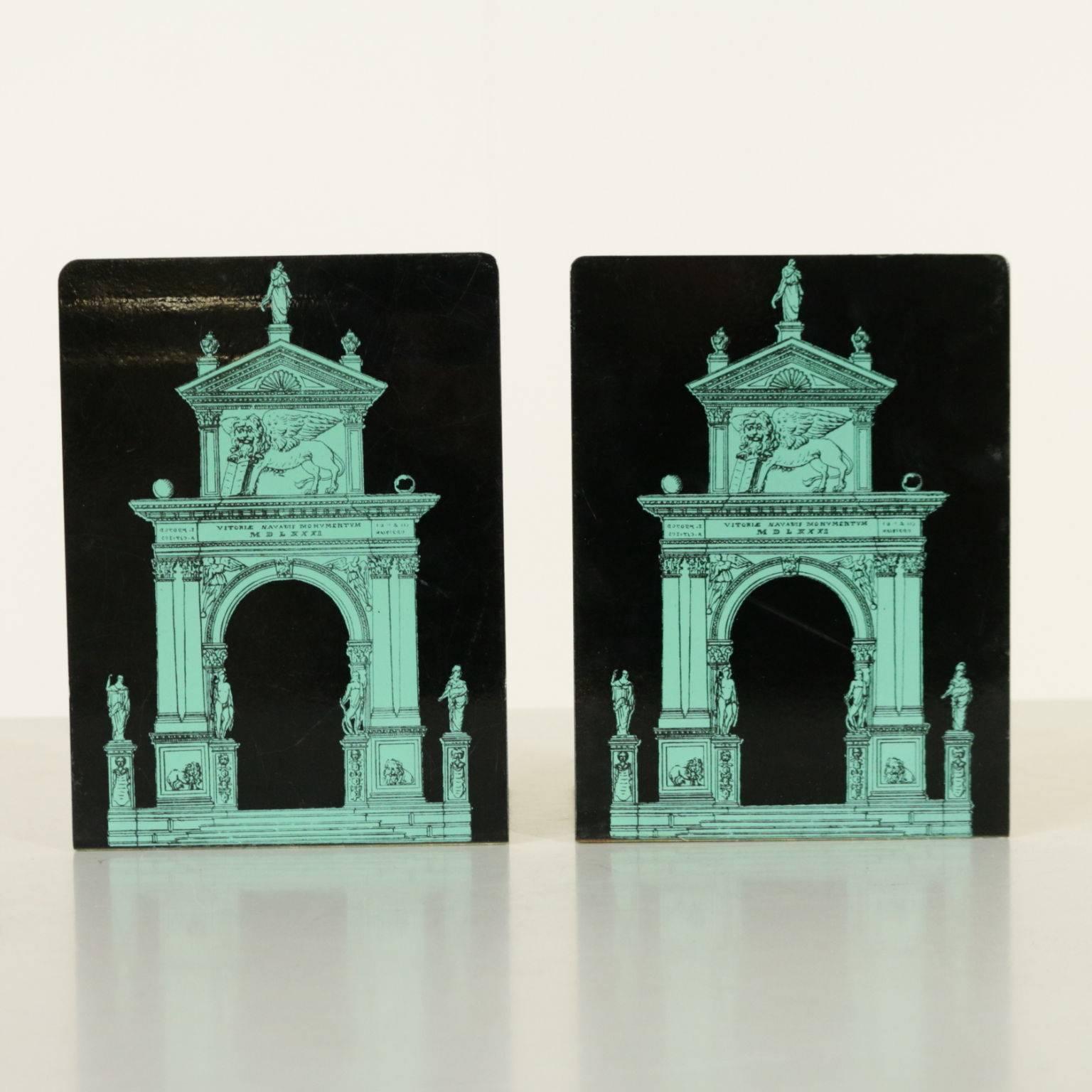 Pair of enamelled metal bookends designed by Piero Fornasetti with screen painted decorations. Manufacturing brand under the base. Manufactured in Milano, Italy, 1960s.