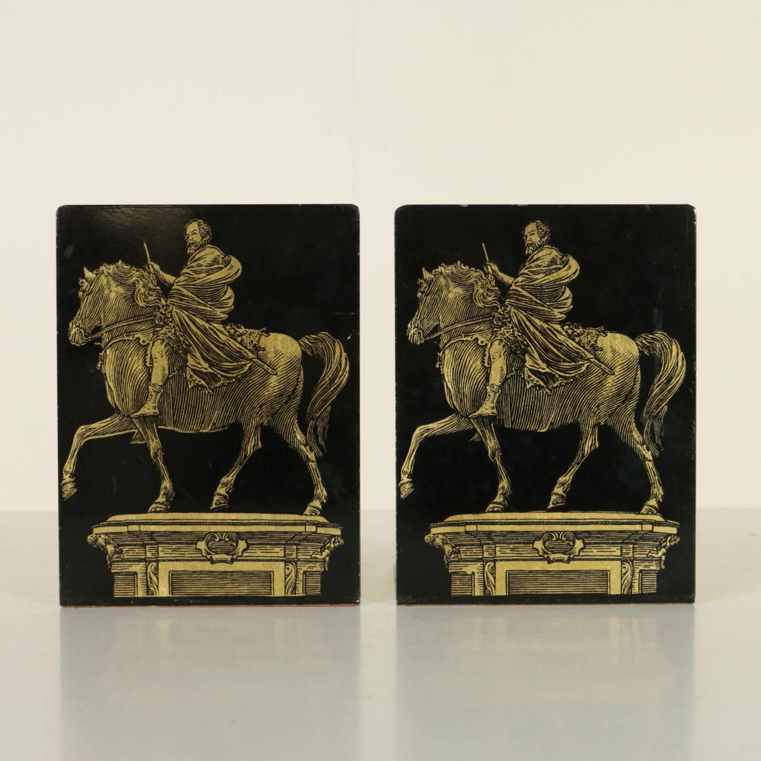 Pair of enamelled metal bookends designed by Piero Fornasetti with screen painted decorations. Manufacturing brand under the base. Manufactured in Milano, Italy, 1960s.