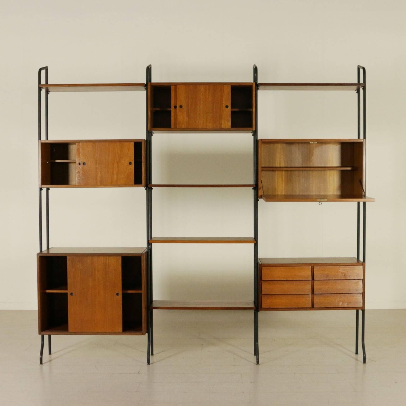 A bookcase with adjustable elements in height, teak veneer and metal uprights. Manufactured in Italy, 1960s.