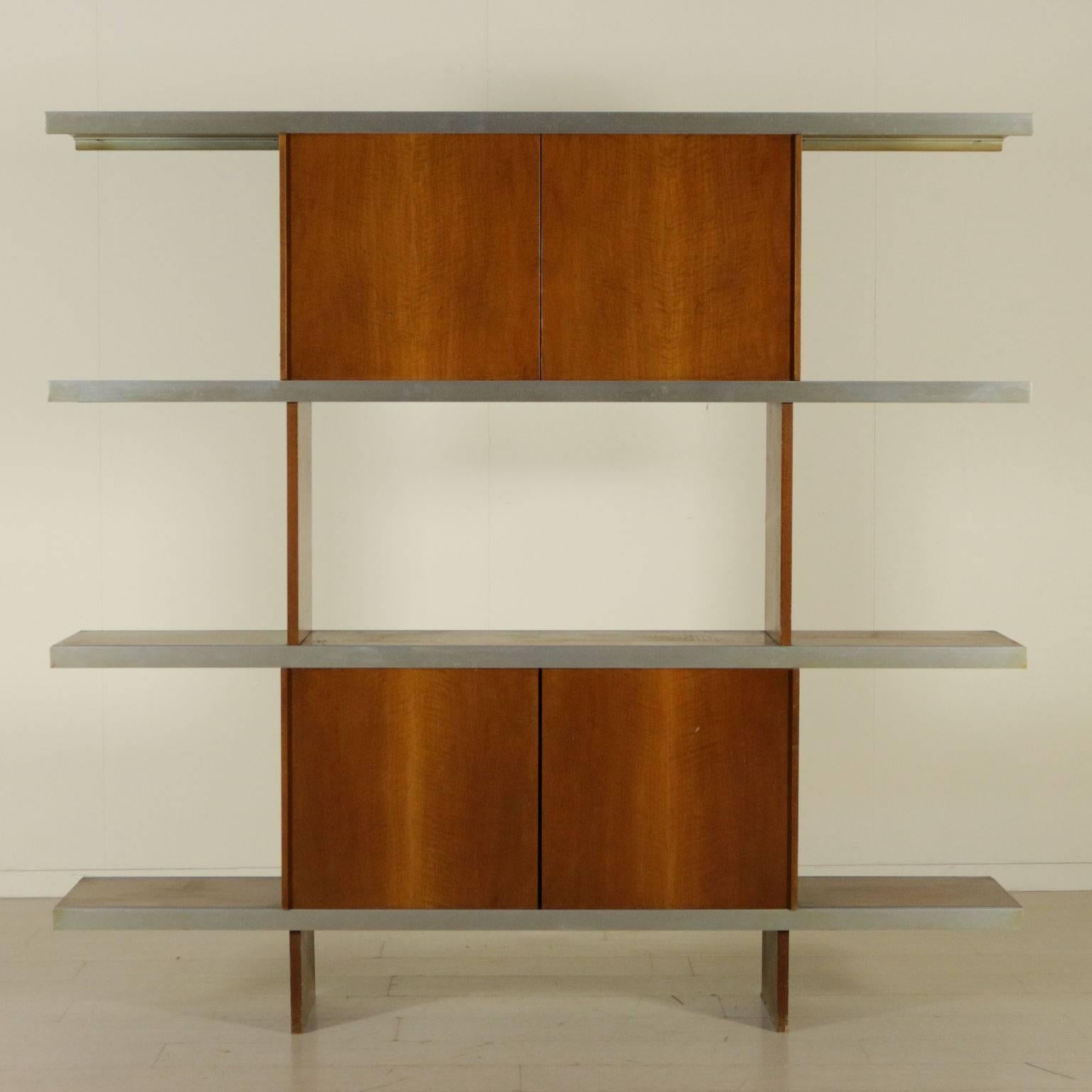 A bookcase with sliding doors on aluminium rails. Designed by Angelo Mangiarotti (1921-2012) for Poltronova in 1965. Model: Multi-use. Tanganika walnut veneer. Manufactured in Italy, 1970s.