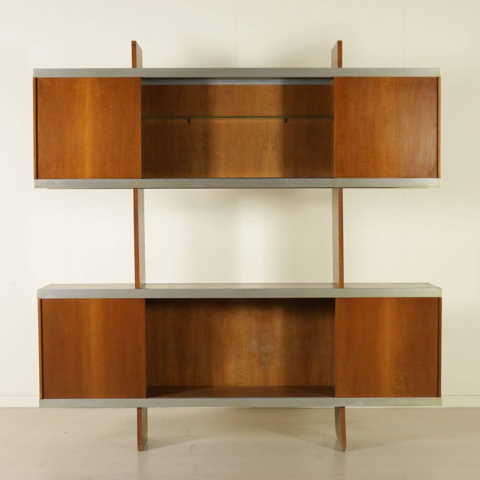 A bookcase with sliding doors on aluminium rails. Designed by Angelo Mangiarotti (1921-2012) for Poltronova in 1965. Model: Multi-use. Tanganika walnut veneer. Manufactured in Italy, 1970s.