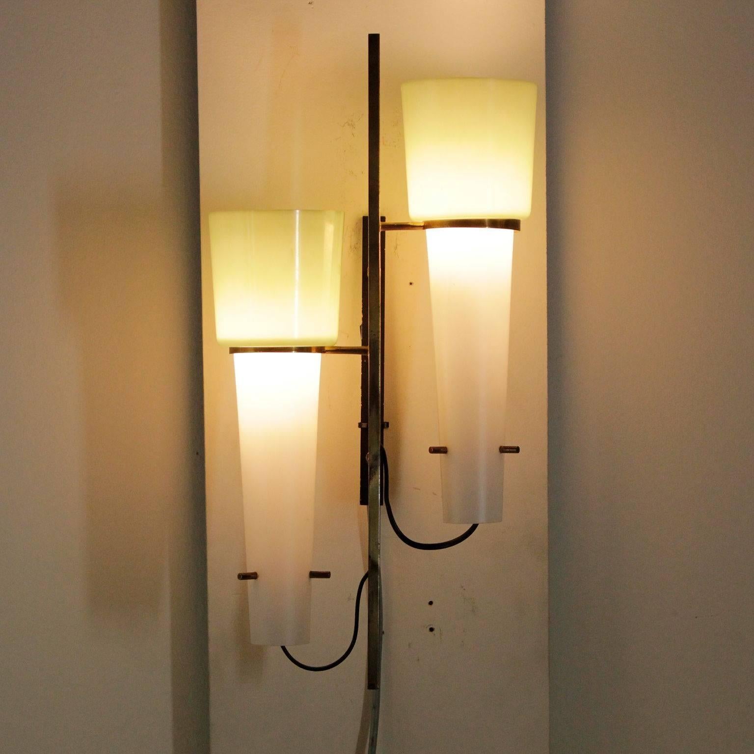 A wall lamp, metal, brass and glass. Manufactured in Italy, 1950s-1960s.
