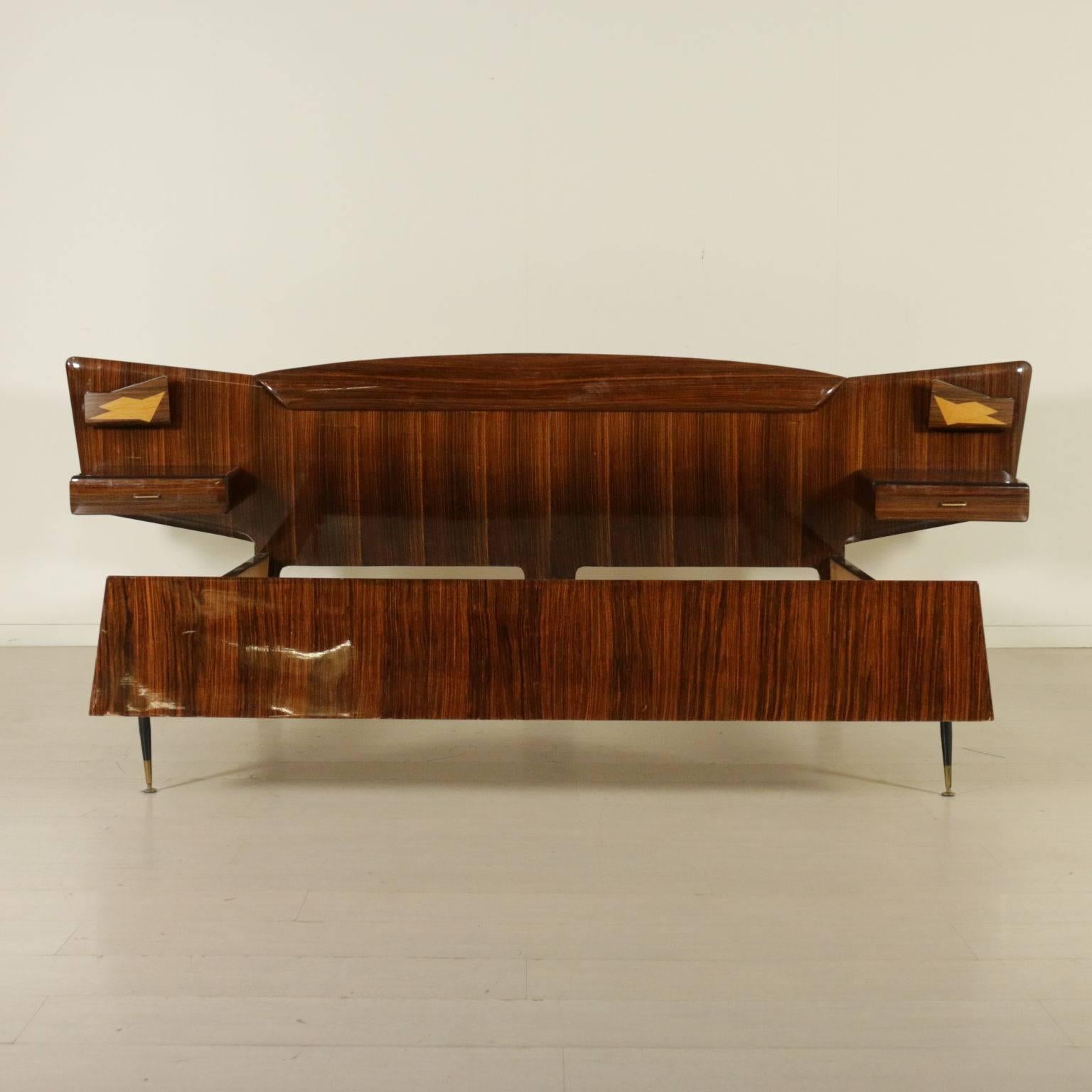 A double bed with hanging bedside tables, rosewood veneer. Manufactured in Italy, 1950s-1960s.