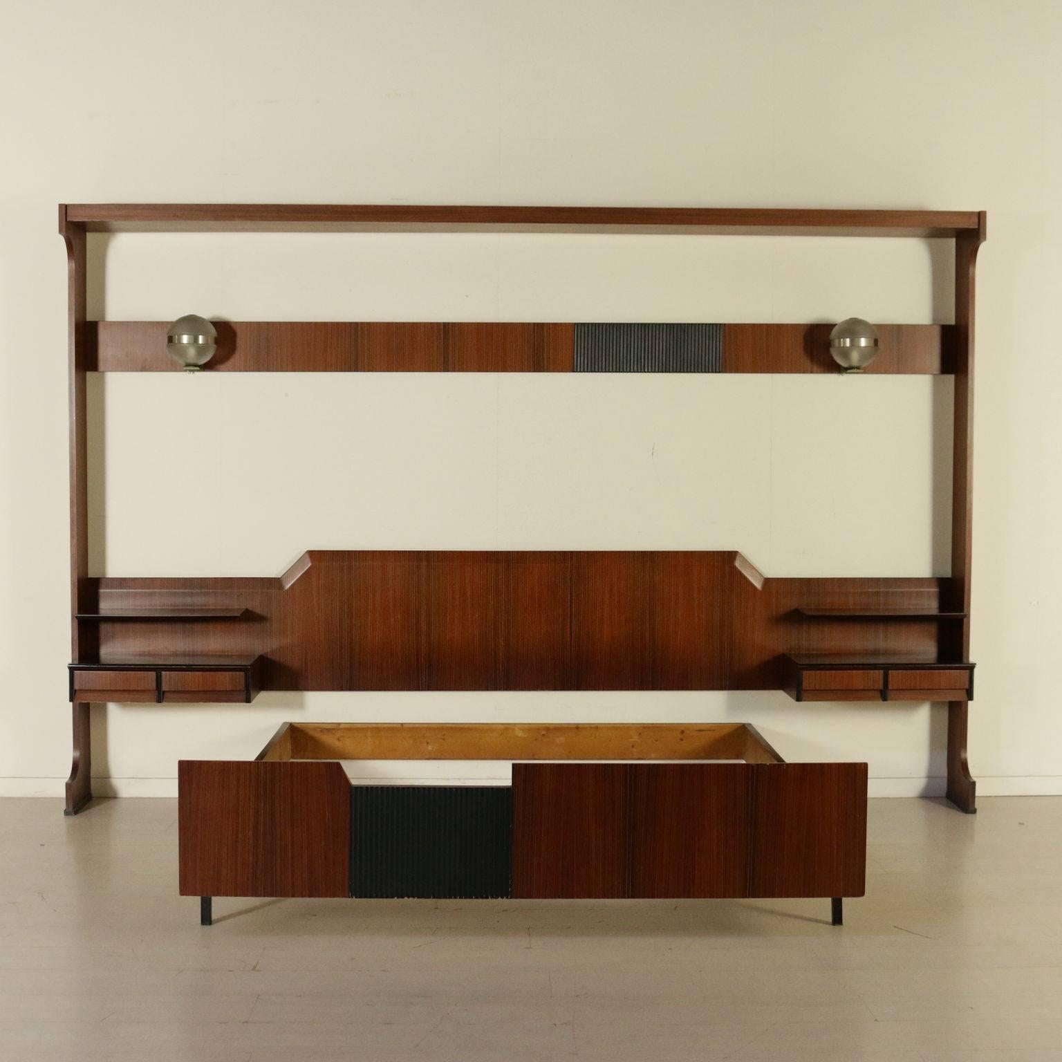 A double bed with hanging bedside tables, rosewood veneer, stained ebony panel. Manufactured in Italy, 1960s.