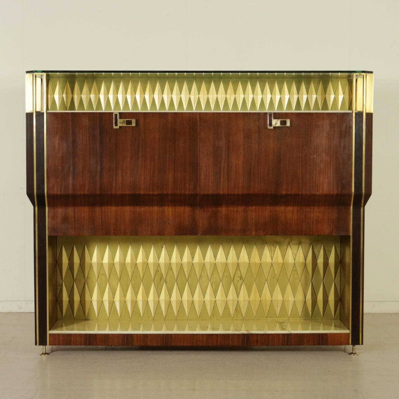 A bar cabinet designed by Vittorio Dassi for Consorzio Esposizione Mobili Cantù, rosewood veneered wood. Beech veneered interiors covered with mirrored glasses and Formica. Ornamental diamonds made of lacquered and gilded wood. Brass, marble and