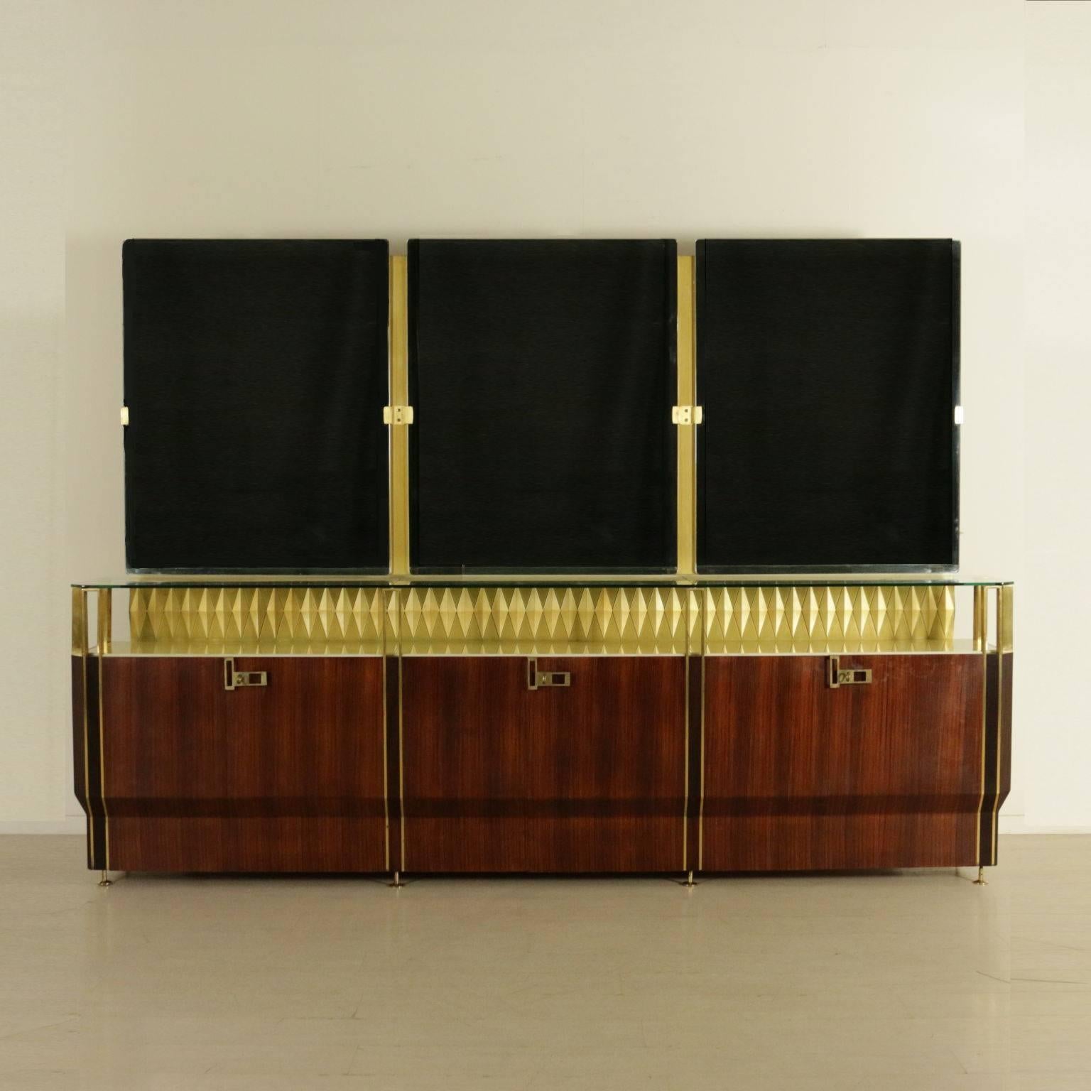 A buffet with mirror with backlighting designed by Vittorio Dassi for Consorzio Esposizione Mobili Cantù. Rosewood veneered wood, Formica and beech veneered interiors, ornamental diamonds made of lacquered and gilded wood. Brass, marble and glass.