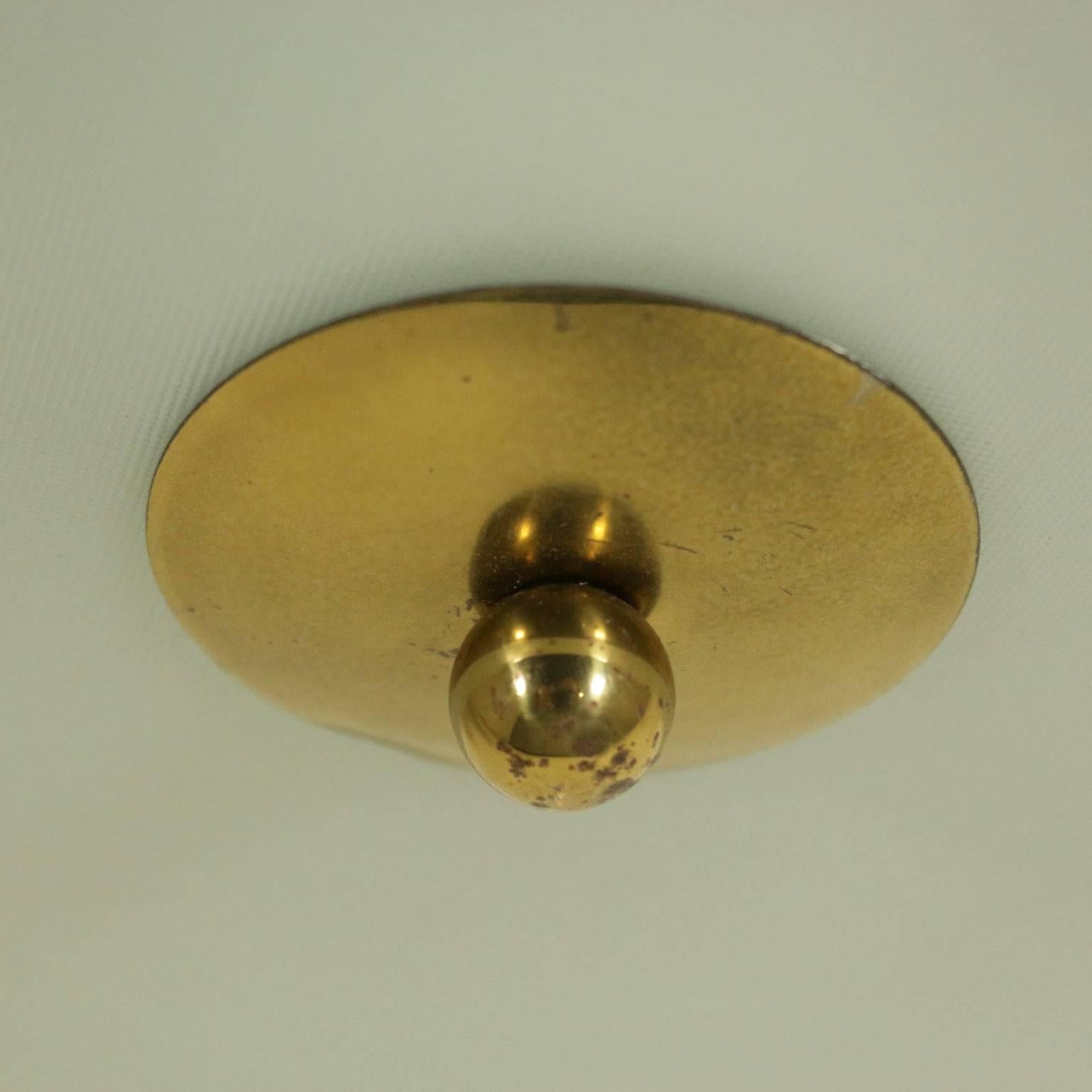 A ceiling or wall lamp in the style of Pietro Chiesa. Metal, brass and knurled glass. Manufactured in Italy, 1950s.