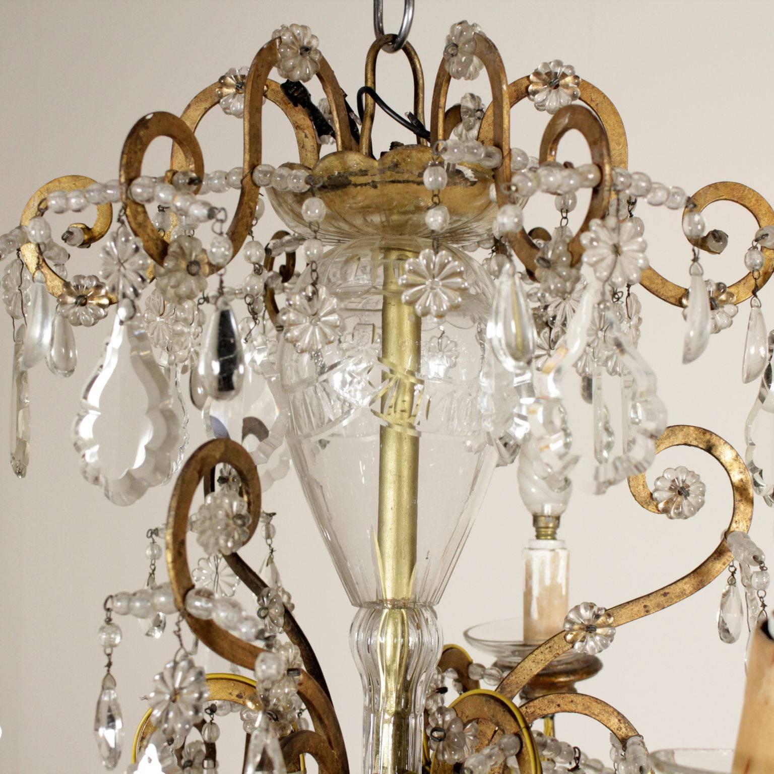An antique ceiling lamp with gilded iron volutes and nine-light points. Embellished with glass and crystal pendants. 18th century.