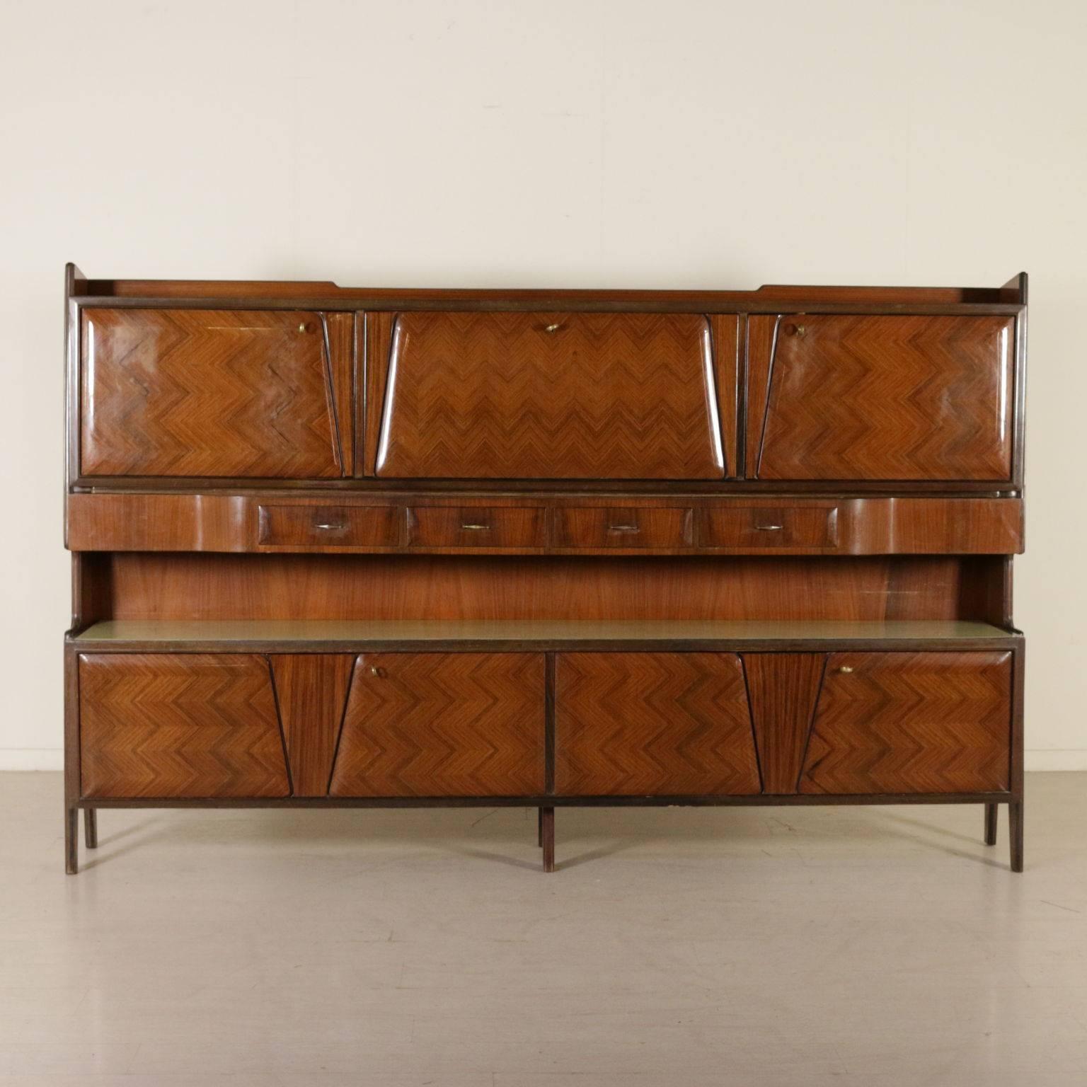 A cupboard with central drop-leaf secretaire, rosewood veneer, retro treated glass, marble effect. Manufactured in Italy by La Permanente Mobili Cantù, 1950s-1960s.