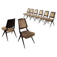 Eight vintage chairs with brass legs from the 1950s–1960s, with the wooden parts restored