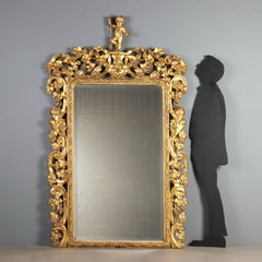 Espejo de estilo barroco de madera de pino cembro dorada, Italia, siglo XIX
