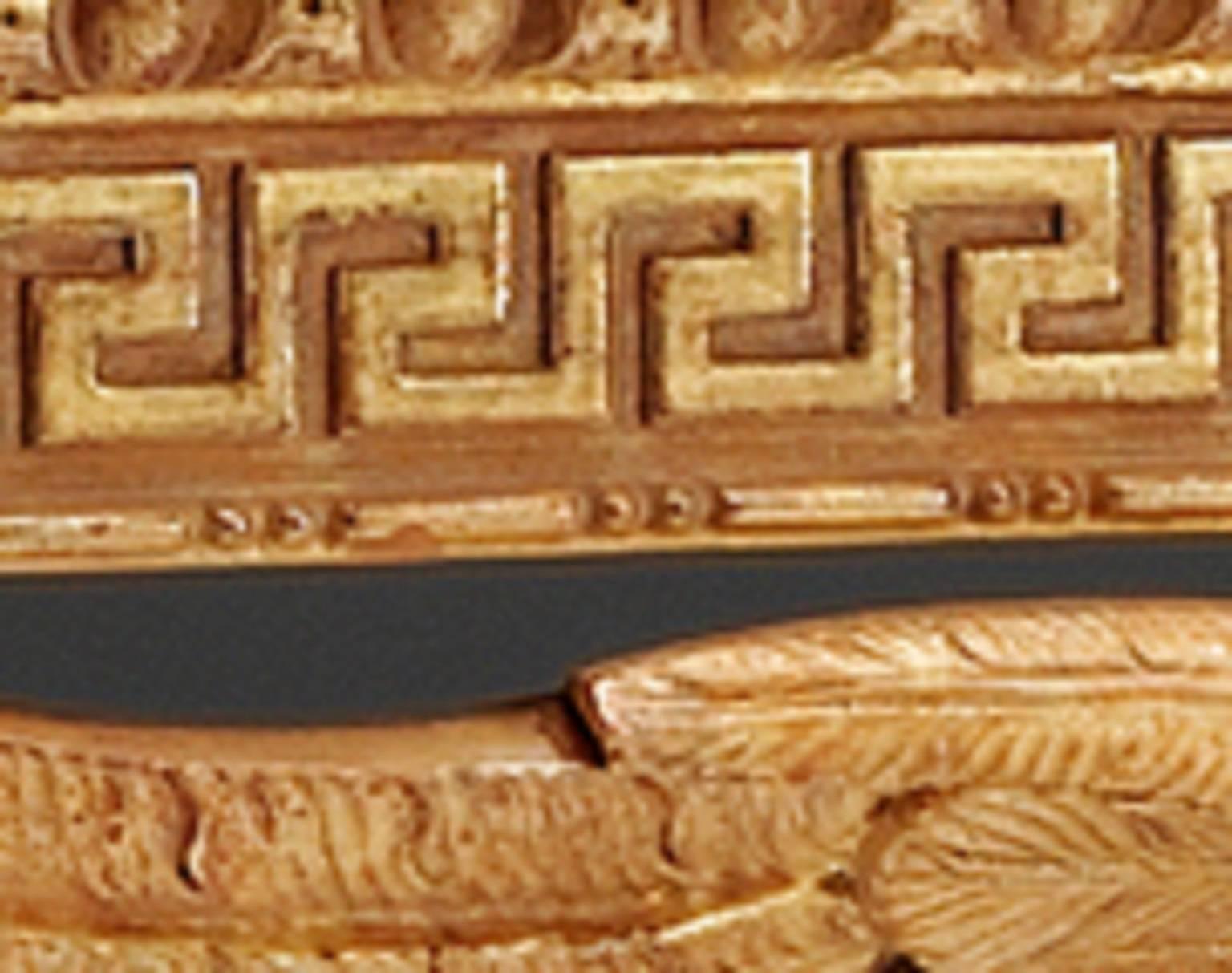 A pair of carved giltwood console tables in the style of William Kent and the reign of George II. The marble tops rest above the egg and dart and Greek key pattern moulded friezes. The naturalistically carved eagles, with outstretched wings, Stand