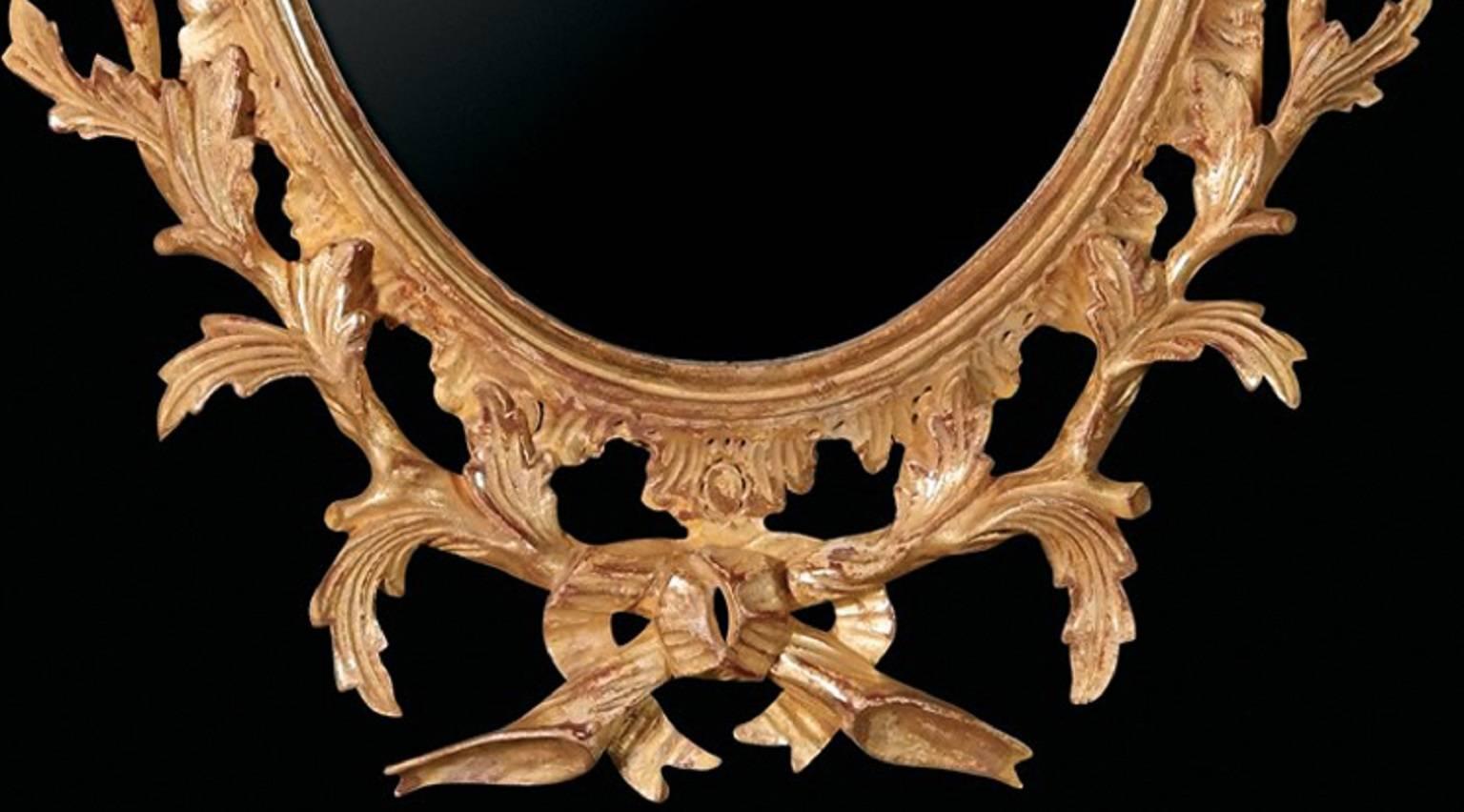 These small carved giltwood oval mirrors of Chippendale design illustrate the English Rococo period of the middle years of the 18th century.

These small oval looking glasses are in a moulded inner frame carved in rocaille and surrounded by