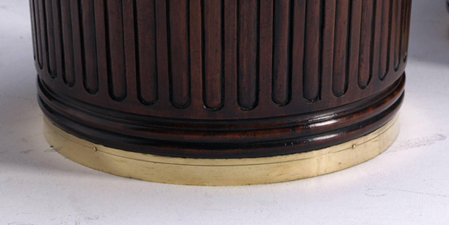 A pair of stop fluted, carved mahogany, brass bound Georgian design peat buckets with twist grip loop handles and fitted brass liners. These buckets are finished to a fine 18th century finish.

Can also be used as a waste bin, trash can or ice