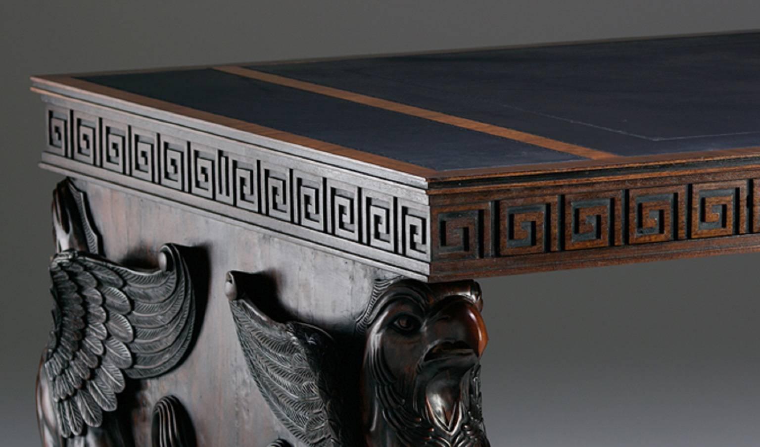 An important Regency design carved wood pedestal desk in the manner of Charles Heathcote Tatham. The top is symmetrically divided and leathered. The frieze, of Greek key, conceals two large secret drawers, which are key operated. The bases being of
