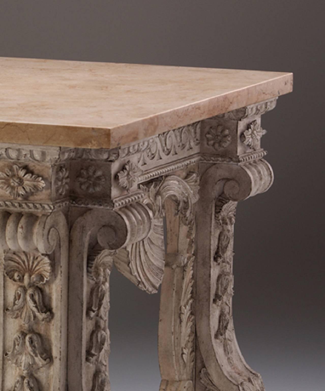 An important architectural side table after a design by Matthias Lock, the Hercules mask draped with the pelt of the Nemean lion hung through carved rings, with an architectural design carved and decorated framework, under a vitruvian scroll frieze