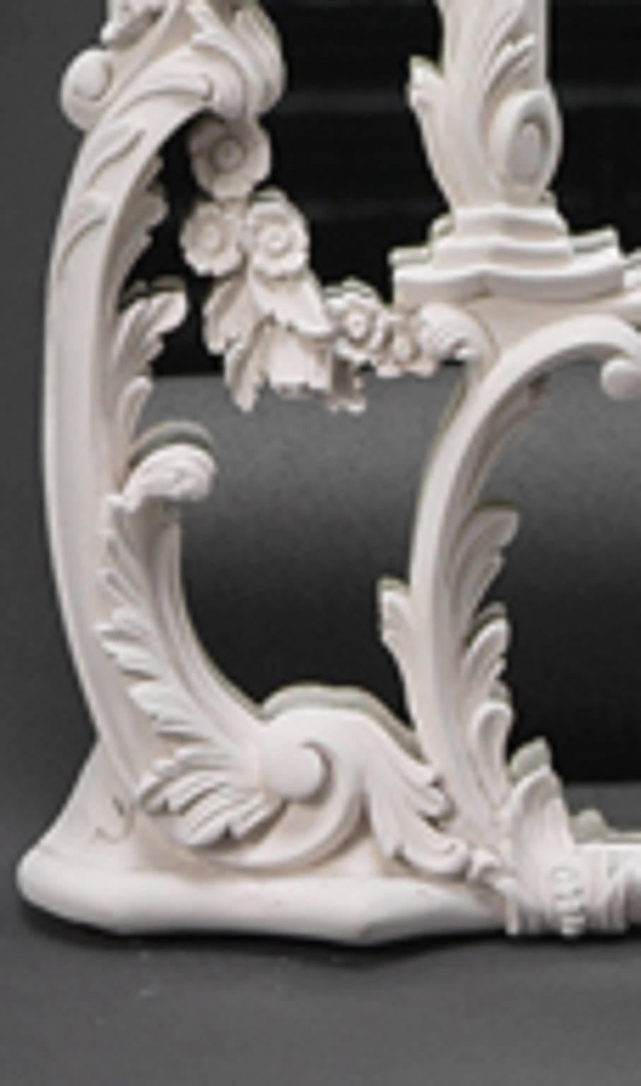 A design attributed to John Linnell. Each arched divided plate within shaped outer slips entwined with foliate branches and leaf scrolls. Each mirror is surmounted by a seated Chinese man and woman holding aloft a foliate parasol. Finished in