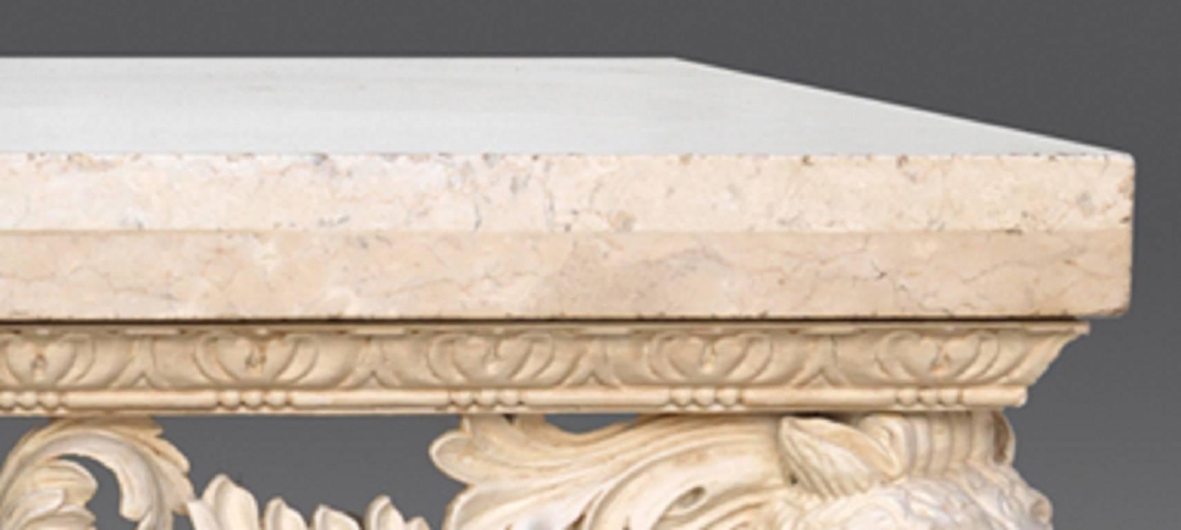 A pair of polished limestone tops supported by seated stylised foxes to each corner flanking scrolling acanthus and oak-leaf swags centered by female masks above scallop shells. These impressive console tables are an example by Benjamin Goodison,