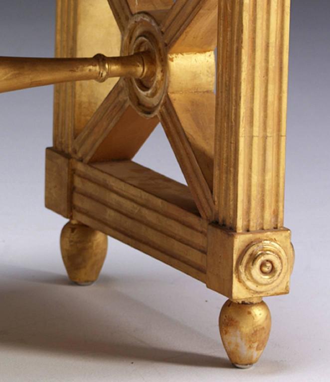 This window bench, or long stool, is taken directly from a design by Thomas Hope (1769-1831). The fluted seat rails are supported by reeded legs, filled with turned discs on crossed, reeded frames. The legs are decorated with paterae and raised on