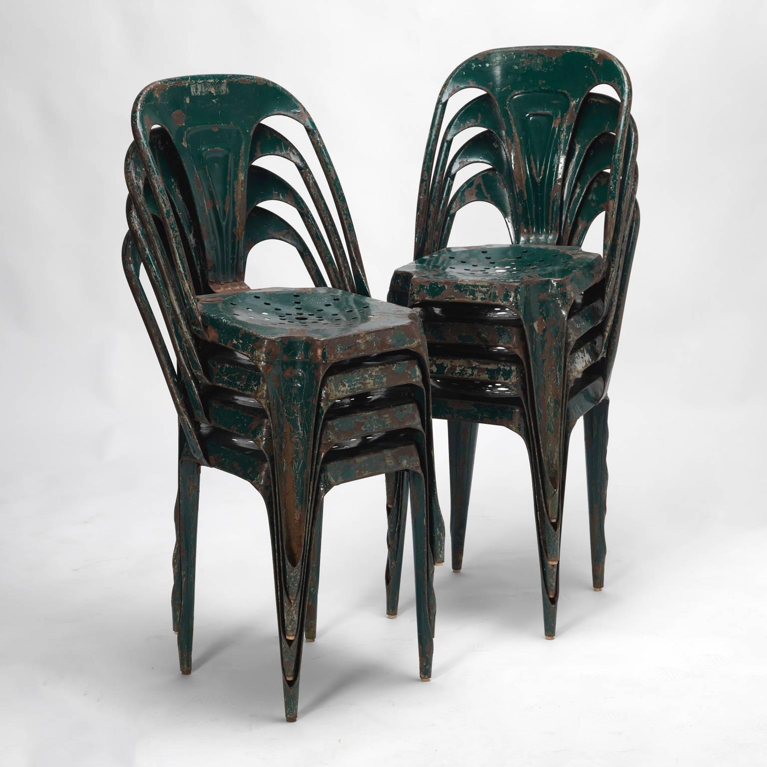 Rare 1950s Tolix Industrial steel structure chairs. One of the first stackable and stainless terrace chairs, known as the Belgian Tolix.

These fantastic original set of eight green Industrial stackable metal bistro chairs. They are in very good