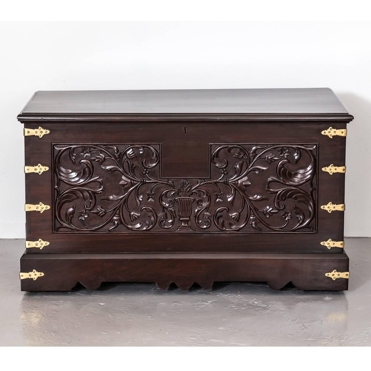 A beautiful Portuguese colonial, so called “Malabar chest” in rosewood. The piece is both decorated and strengthened by vertical brass strips and flattened cusps fixed at intervals round the sides. The front features a carving of curvaceous leafy