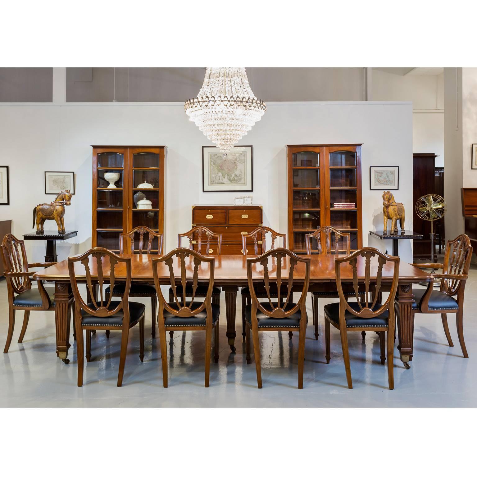 Superb quality 19th century extending dining table with a double moulded edge and a set of ten Hepplewhite shield dining chairs. It is very unusual to find a large antique dining table with all the original chairs still present. 
This amazing table