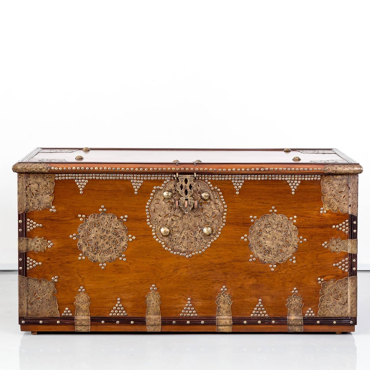 A rare and well preserved chest of solid plank construction in teak wood, beautifully decorated with brass. 
The term “Arab chest” more correctly denotes ownership rather than provenance. In reality, early chests were trade items collected by Arabs