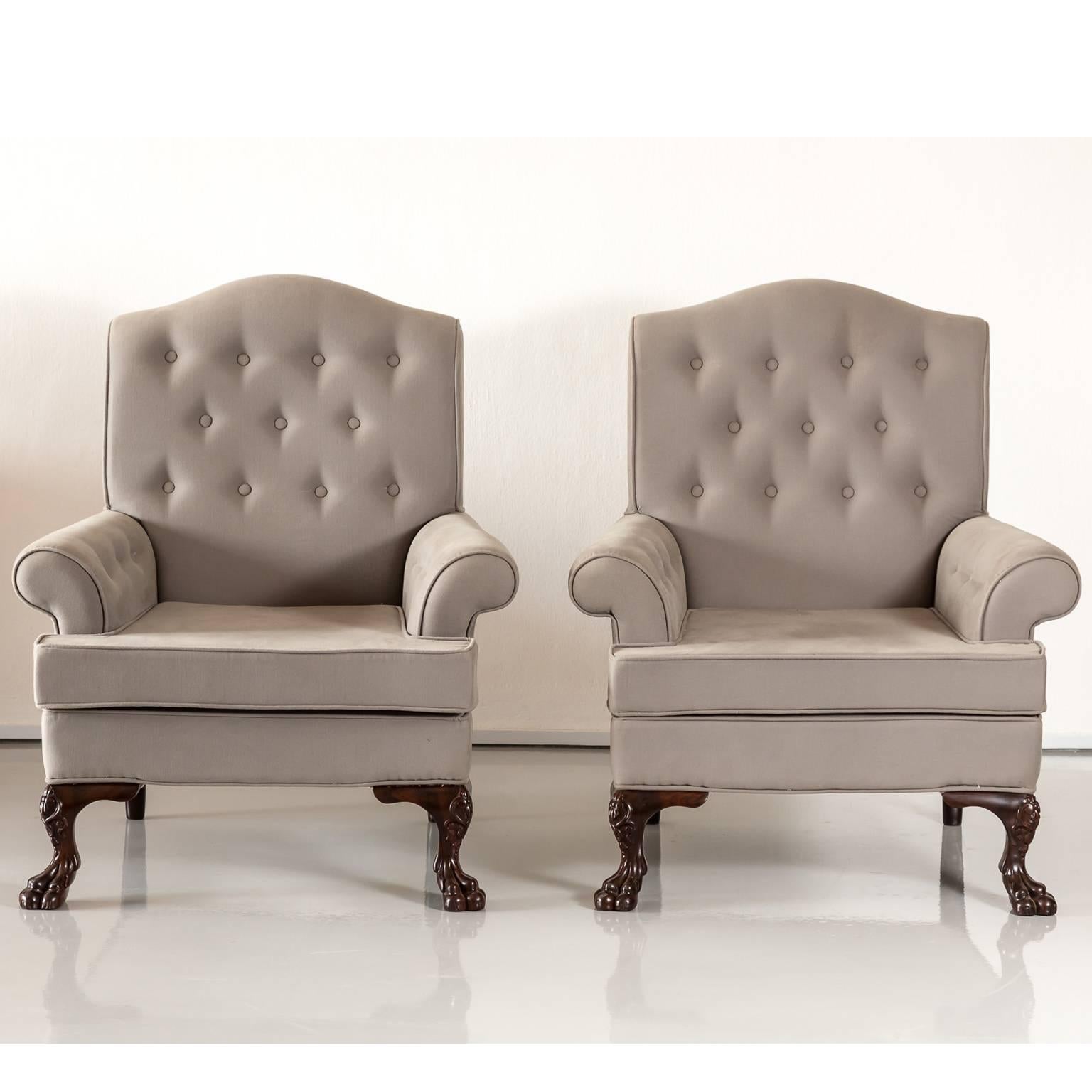 A comfortable pair of British Colonial upholstered Chesterfield style club-chairs. The broad roll of the arms slightly curve out, the back with a serpentine form of the top. The chairs which have a rosewood frame stand on carved cabriole legs ending