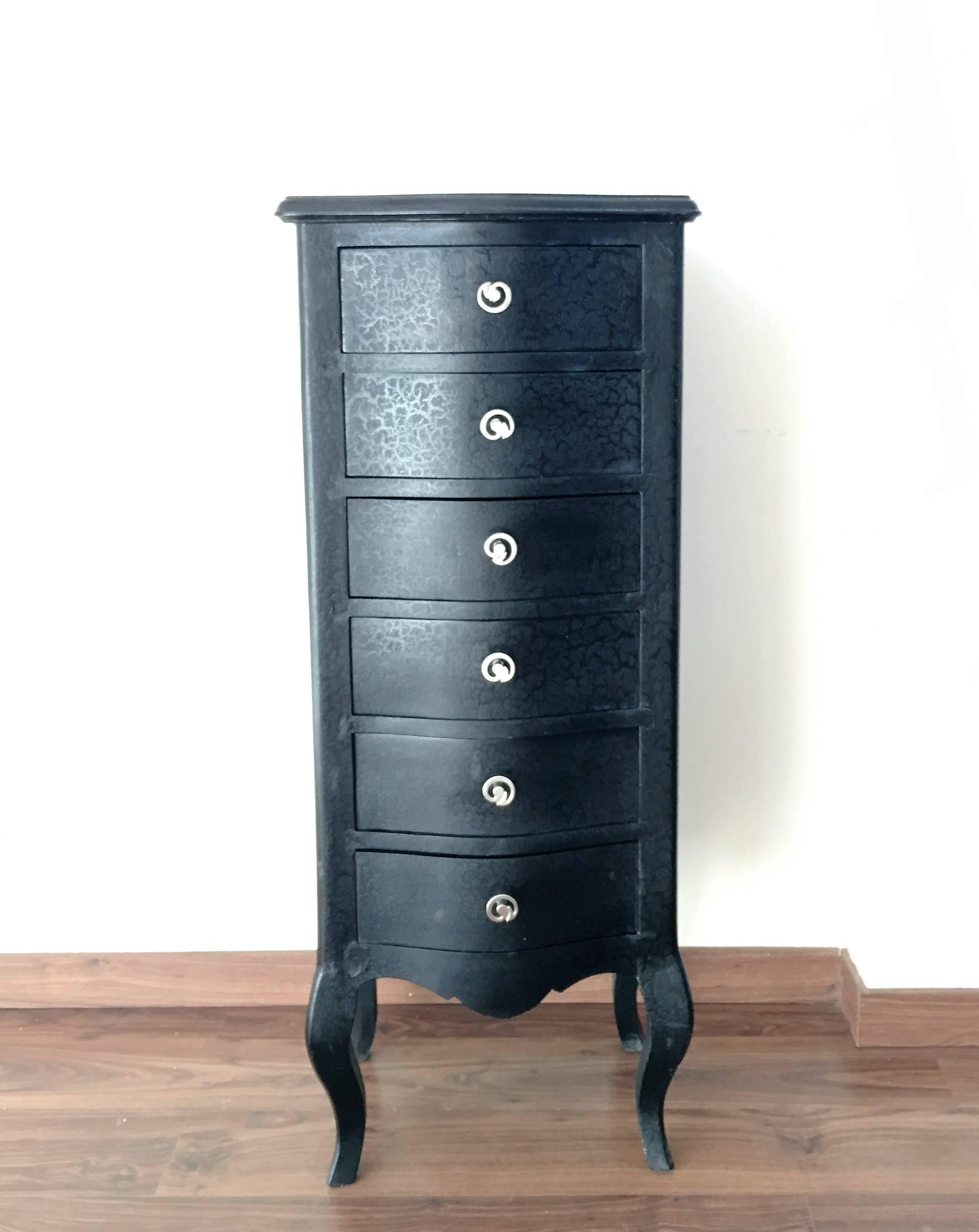Black skin tall chest of drawers.