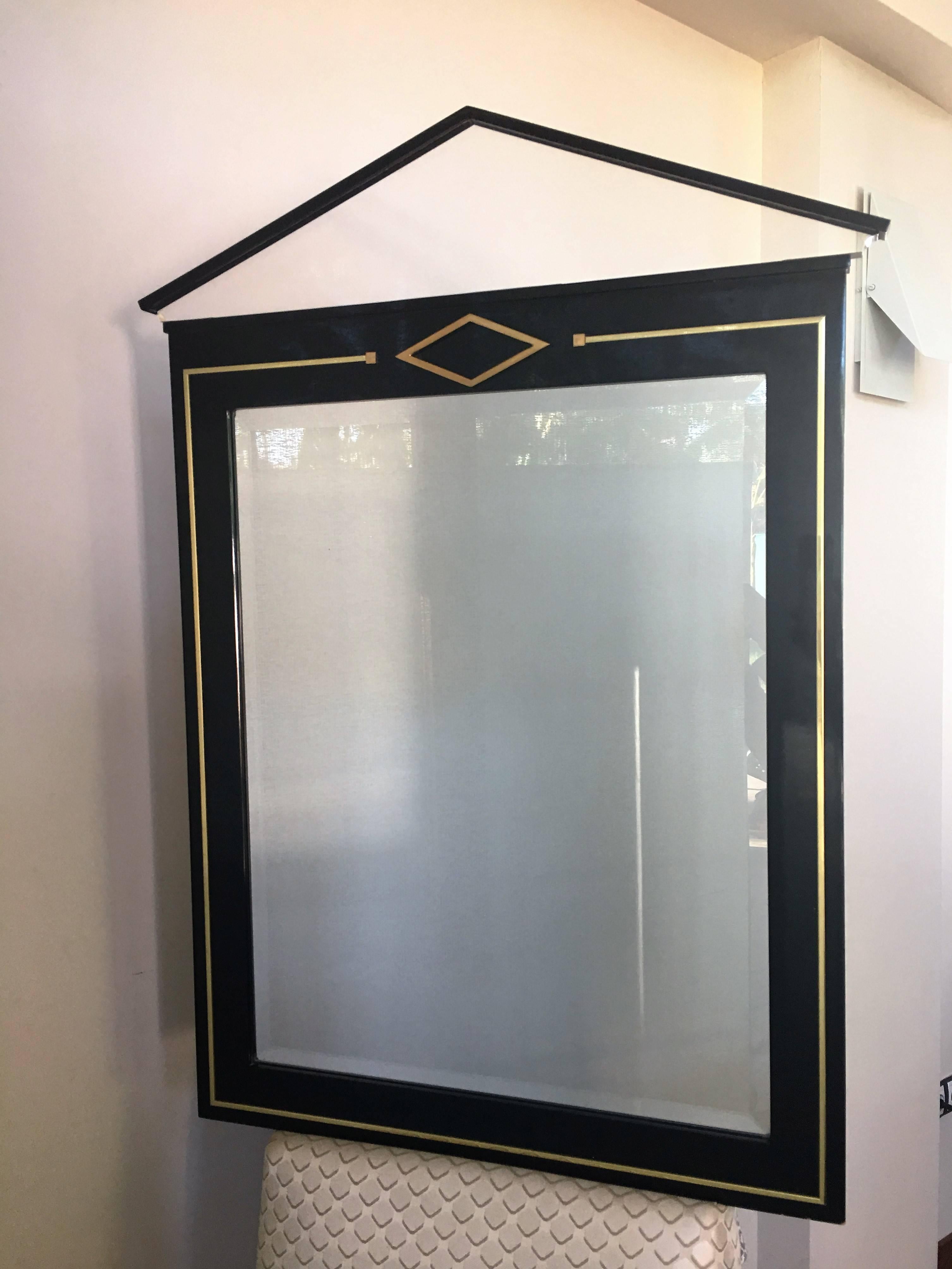 Art Deco Machine Age mirror with inset black vitrolite glass and chrome mounts.
The top is made of Lucite.