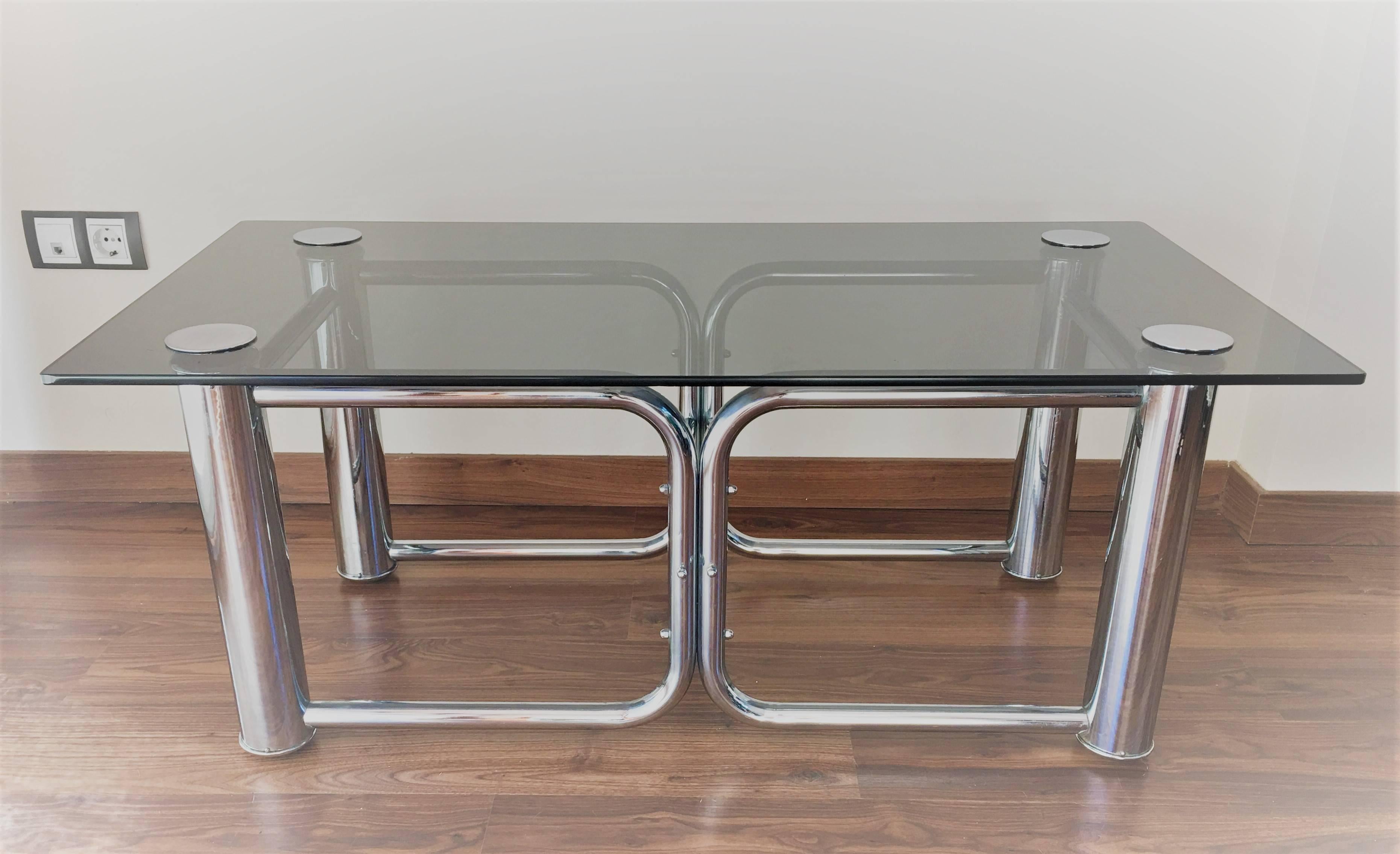 Mid-Century Modern chrome coffee table with smoked glass top.

