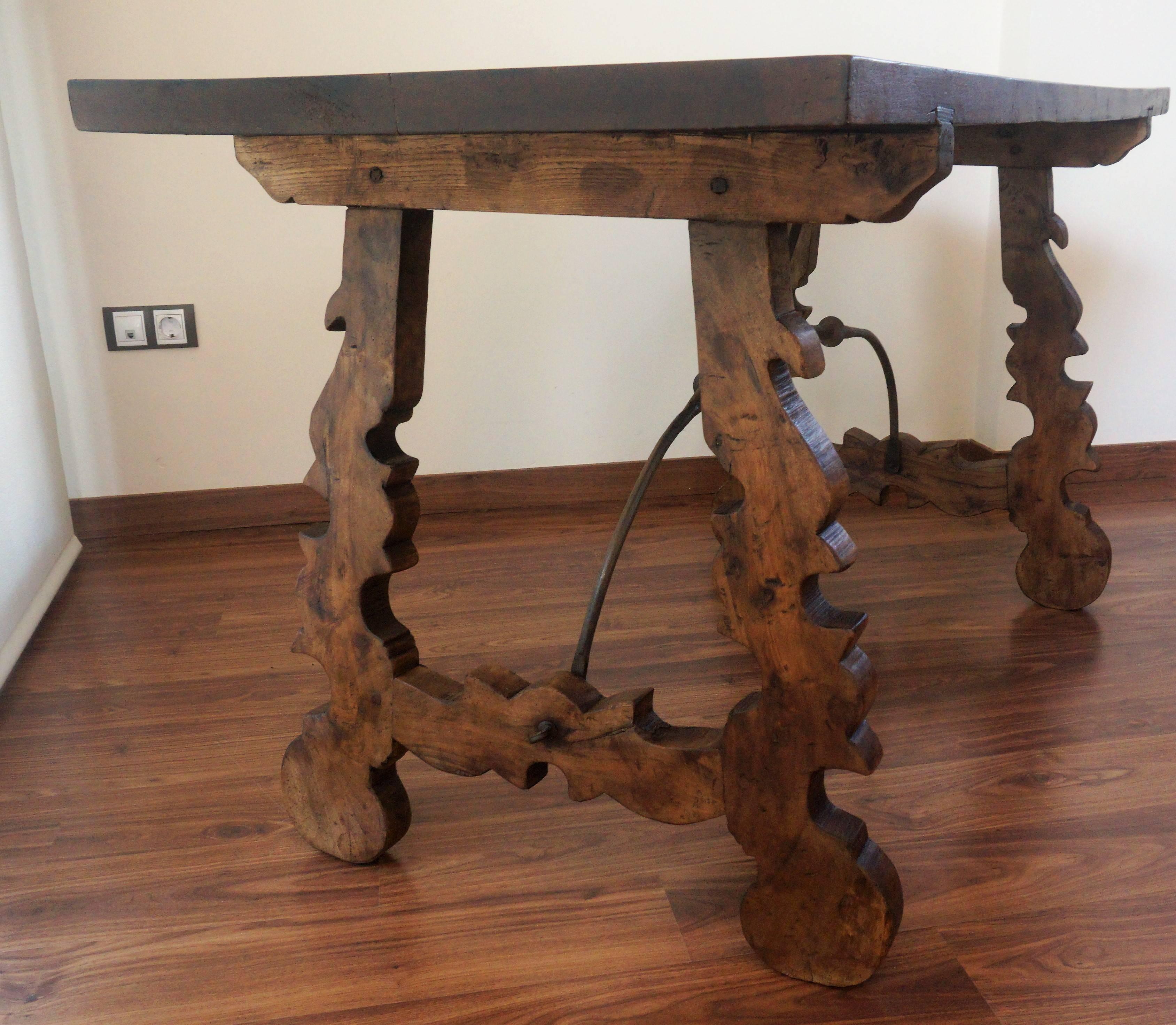 18th century Catalonian dining table with Baroque style lyre legs

This Spanish 18th century table features a rectangular top over an exquisite trestle type base with lyre shaped legs raised on carved volutes. Big thickness of the plateau and
