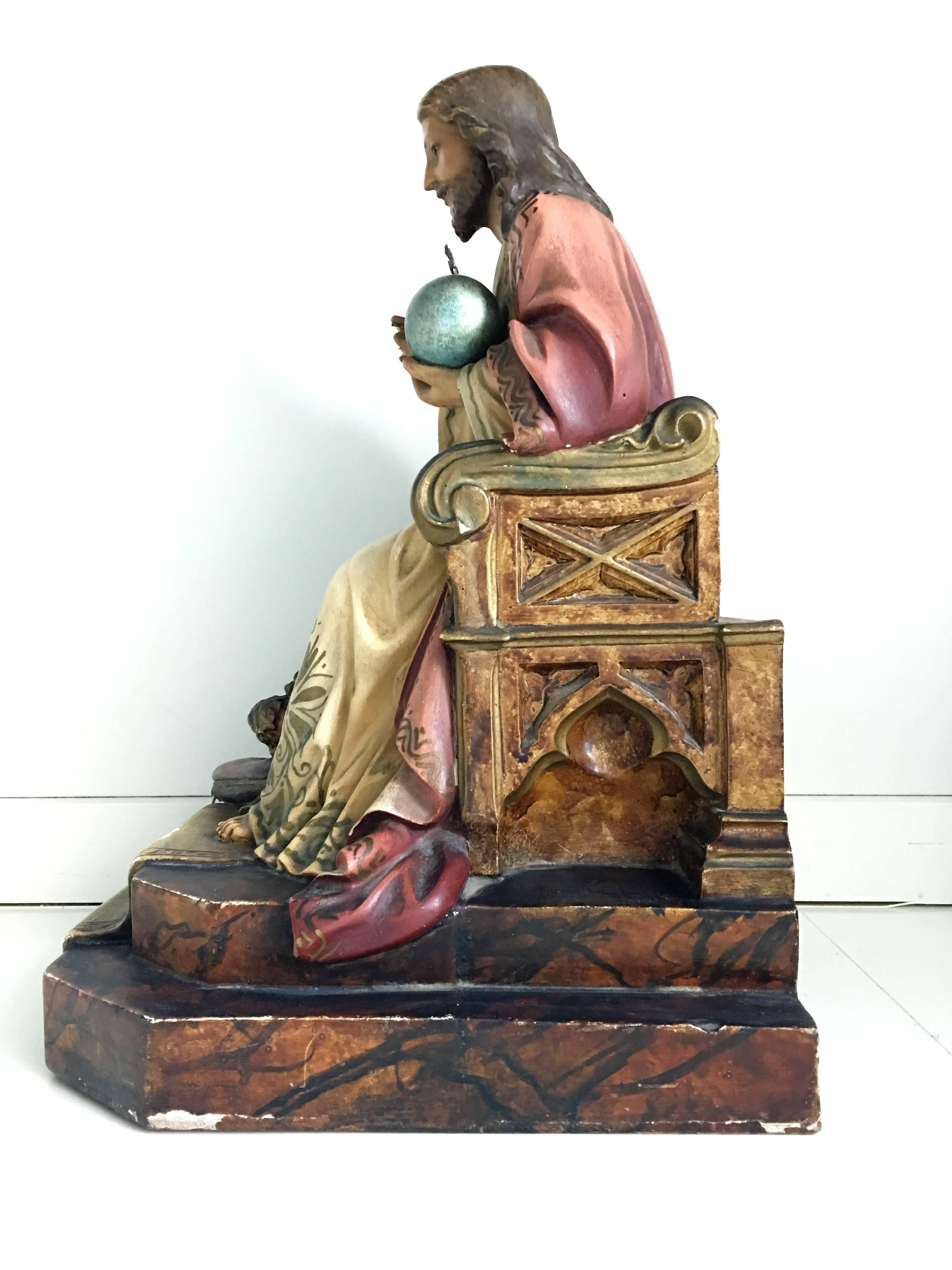 This beautiful statue of Christ was crafted in Spain, circa 1900. The statue features the religious figure standing in a traditional seating pose and showing his Sacred Heart. The sculpture has its original painted finish. The sculpture has a soft,