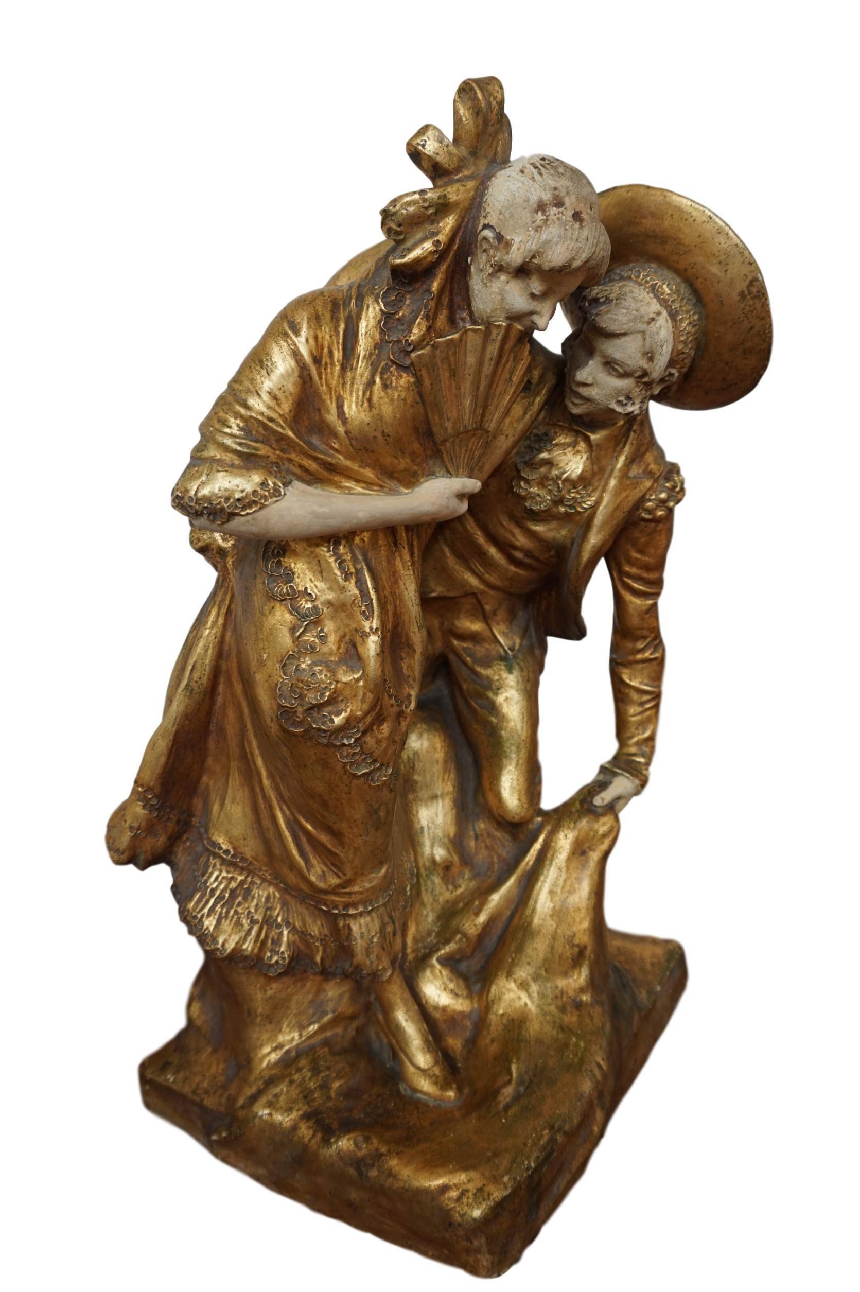 19th century Spanish painted and gilt terracotta statue depicting a loving couple.
This beautiful, statue was crafted in Valencia, Spanish, circa 1860. The statue shows a traditional pose of this period. The sculpture has its original painted